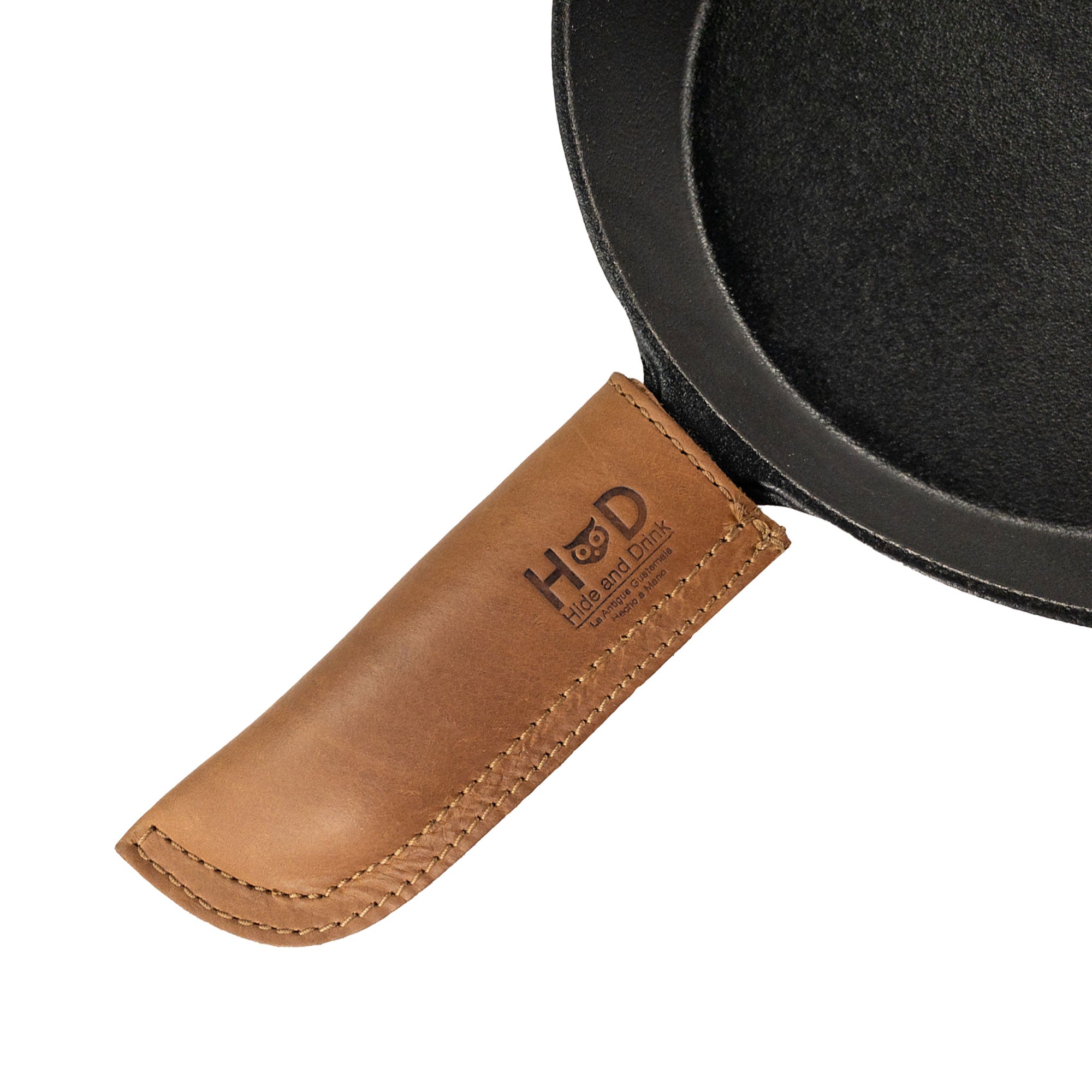 Hot Pan Handle Cover by Hide & Drink, highlighting a sturdy grip design made for cast iron skillets, crafted from premium full grain leather, handmade in La Antigua Guatemala & Oaxaca Mexico.