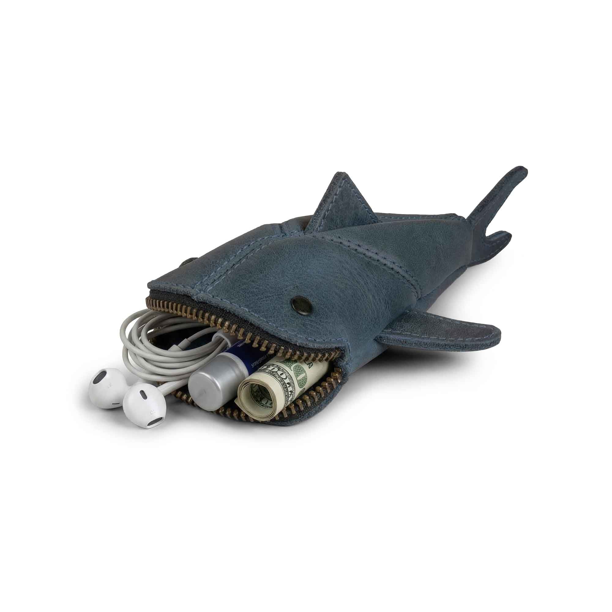Hide & Drink Leather Shark Pouch featuring a small shark-shaped design. This chic Leather Coin Purse is a perfect small charger cable holder, making it ideal as a change bag or zippered cable case. It's great for cash, serving as a tiny travel carrier crafted from full grain leather. Each pouch is part of small batch production, hand cut and hand sewn by artisans, fire branded, and made in La Antigua Guatemala & Oaxaca Mexico.