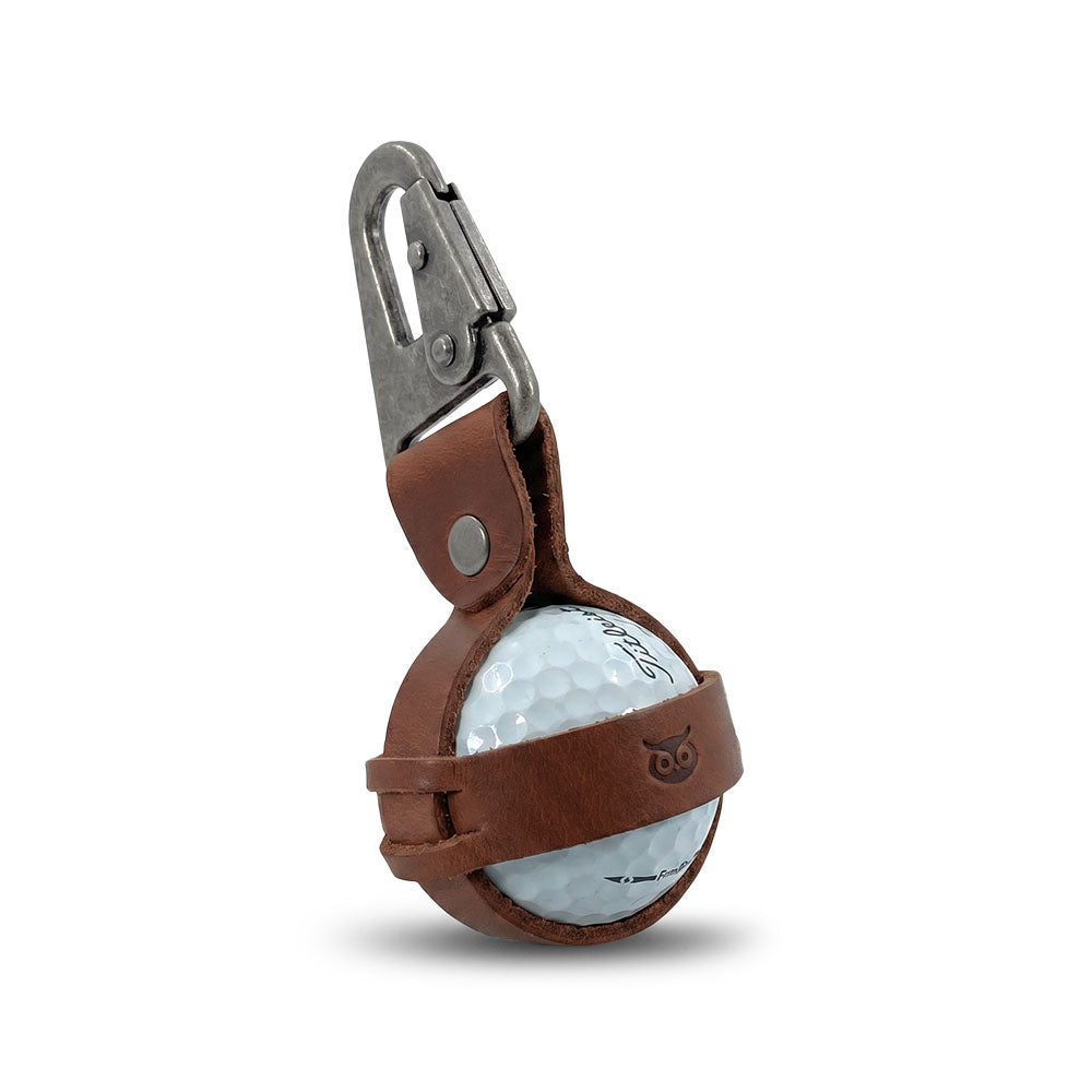 Premium Golf Ball Holder by Hide & Drink securely holds a golf ball, featuring a durable belt loop hook. Made from rustic full grain leather, this artisan-crafted item is hand cut, hand sewn, and fire branded in La Antigua Guatemala & Oaxaca Mexico.