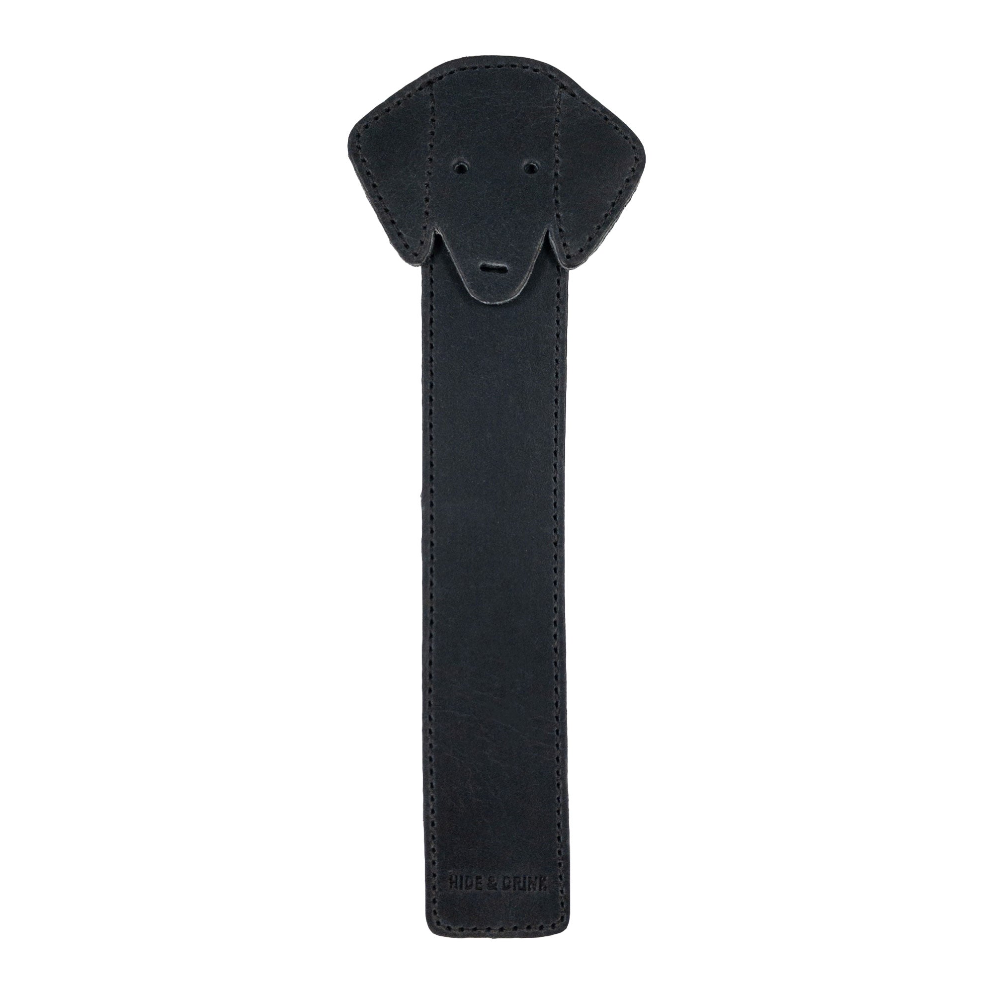 The front view of Hide & Drink's Dog Bookmark in black Full Grain Leather, showcasing its unique dog design. This artisanal bookmark is made through small batch production with careful fire branding, handcrafted in La Antigua Guatemala & Oaxaca Mexico.
