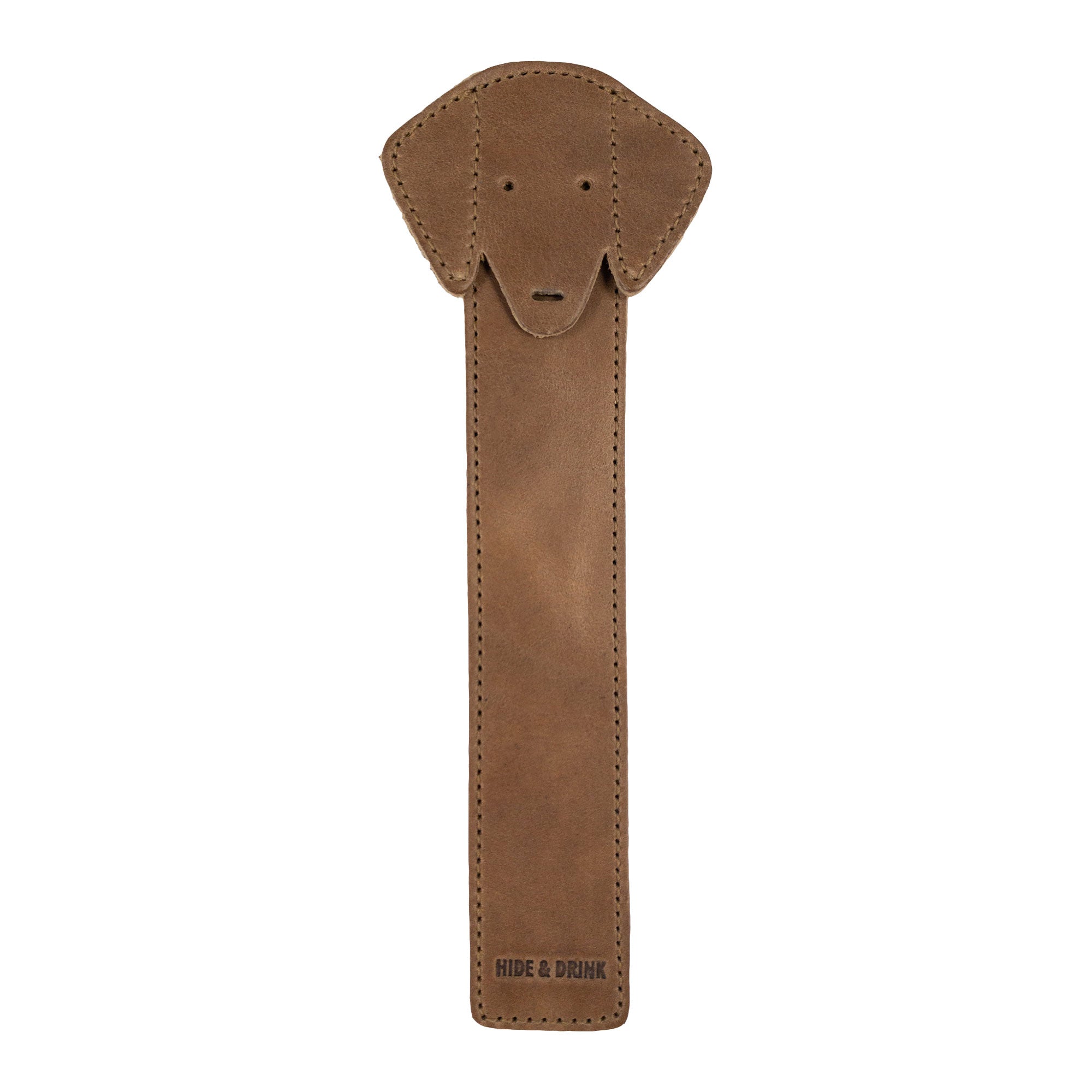 The front view of Hide & Drink's tan Dog Bookmark made from Full Grain Leather, showcasing a cute dog face design. This handmade bookmark exemplifies craftmanship from small batch production and fire branding, made in La Antigua Guatemala & Oaxaca Mexico.