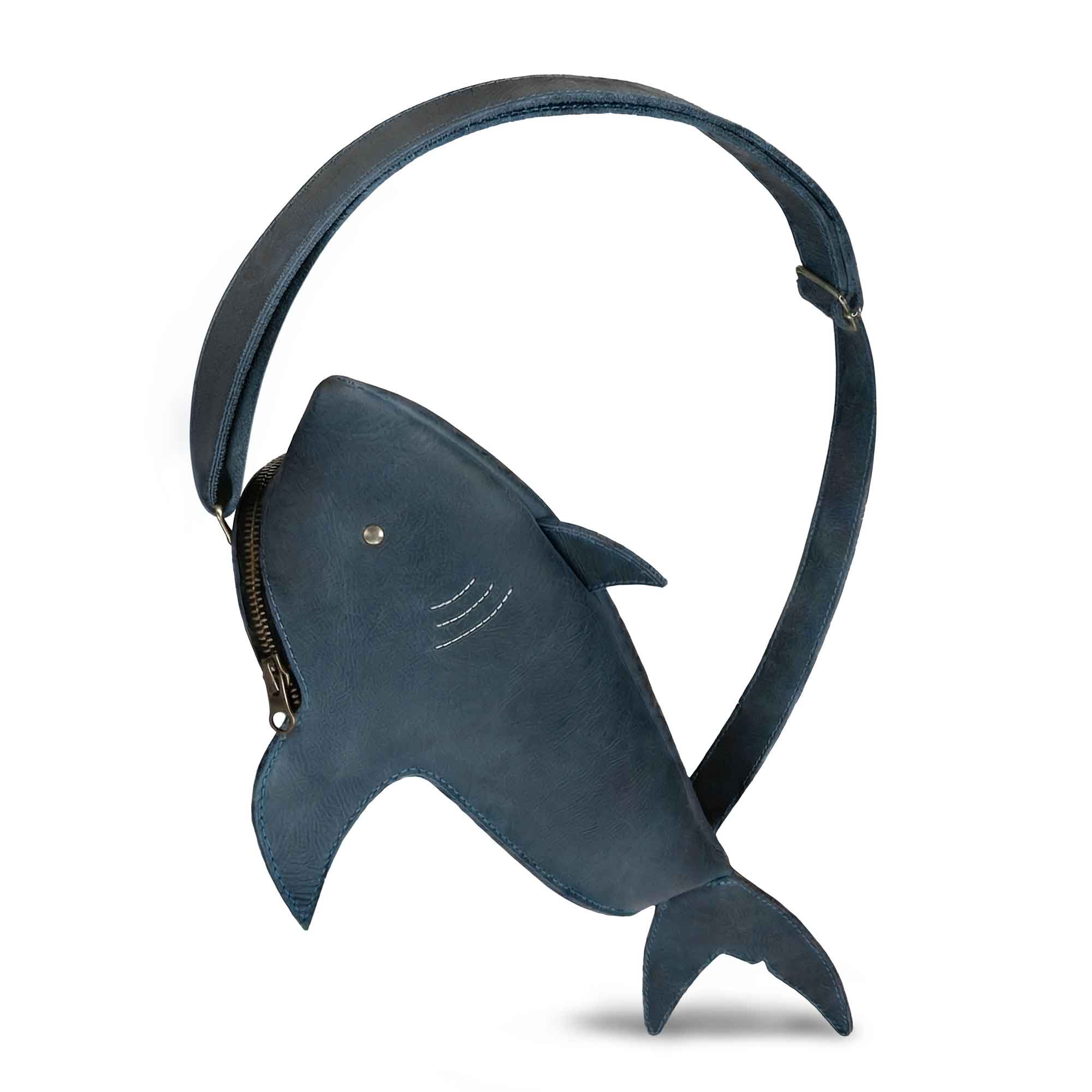 Shark-Shaped Crossbody by Tudi Frudi showcasing a stylish Leather Shark-Shaped Sling Bag with Adjustable Strap. This unique Crossbody Purse is perfect for daily errands, crafted from Full Grain Leather and perfect for women who want a standout accessory. Handmade in La Antigua Guatemala with artisan craftsmanship, it combines style with functionality as a Messenger Bag or Chest Pack Carrier.