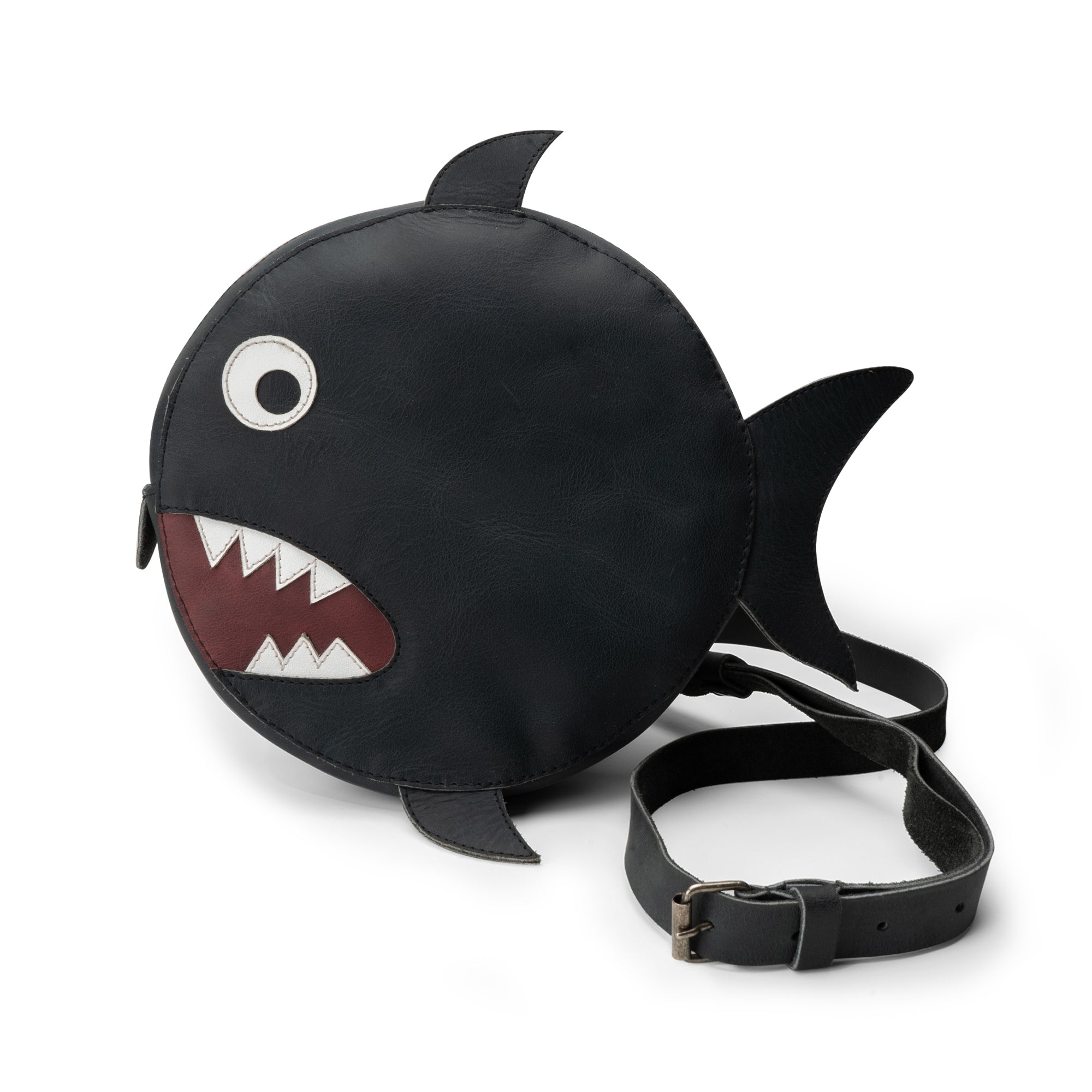 Tudi Frudi's Piranha-Shaped Shoulder Bag features a playful circular design that resembles a piranha, perfect for adding a whimsical touch to any outfit. This Piranha-Shaped Circular Shoulder Bag is crafted from Full Grain Leather, showcasing artisanal quality in its handmade construction with small batch production methods, ideal for casual outings.