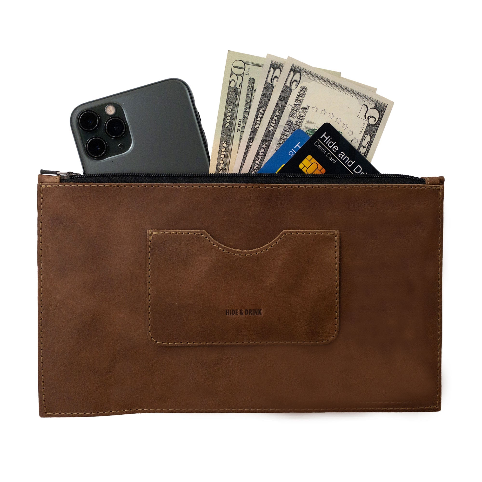 A brown rectangular zippered handbag by Hide & Drink featuring cash and a smartphone inside, designed for women. This full grain leather purse comes with a card slot, reflecting artisan craftsmanship and small batch production, hand cut and sewn in La Antigua Guatemala & Oaxaca Mexico.