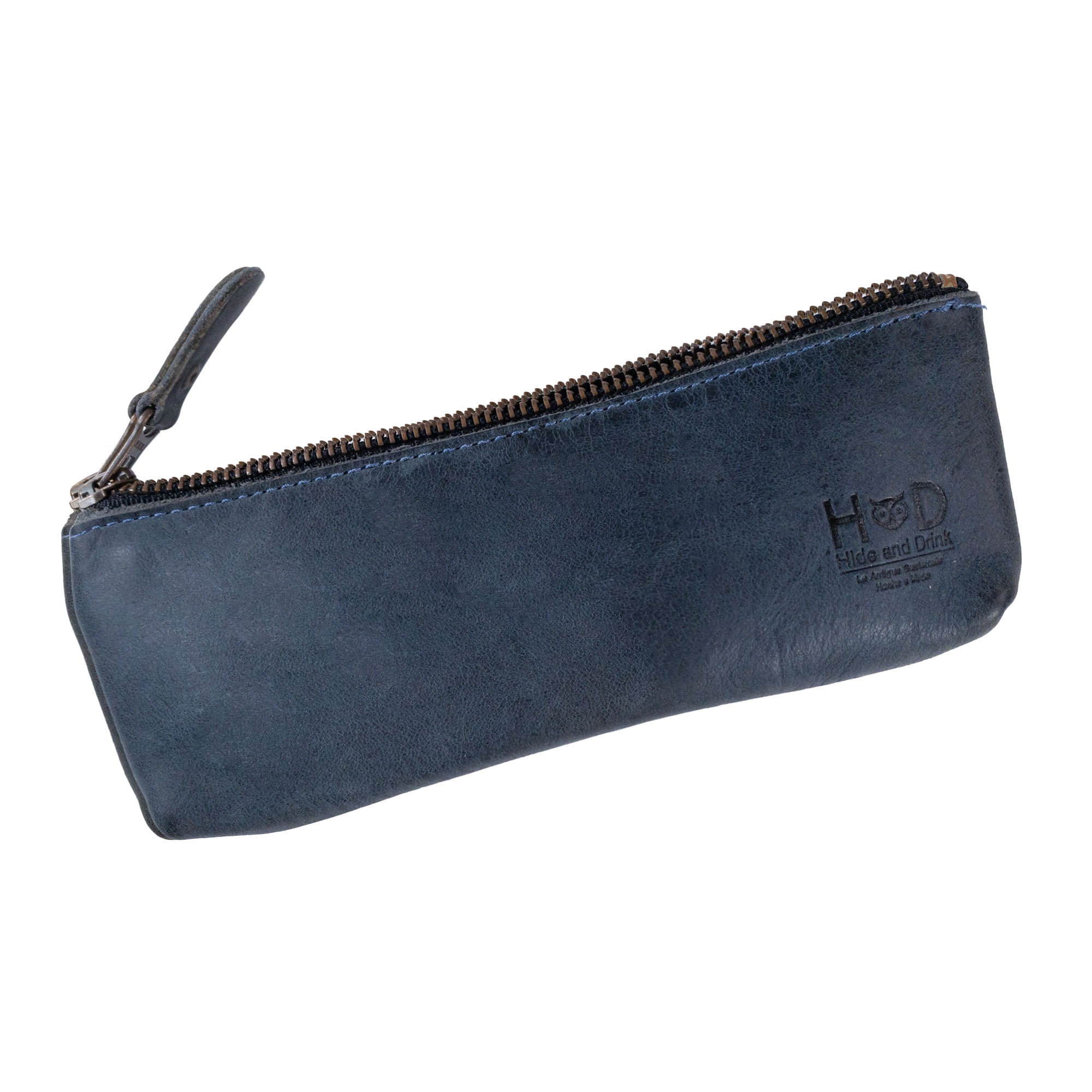Hide & Drink Pencil Pouch made of full grain leather, showcasing a sleek rectangular design in a stylish dark color. Perfect as a pen and marker pouch for men and women, this flat zippered holder reflects classic style for artists. Each pouch is crafted with small batch production, hand cut, hand sewn, and fire branded by artisans in La Antigua Guatemala & Oaxaca Mexico.