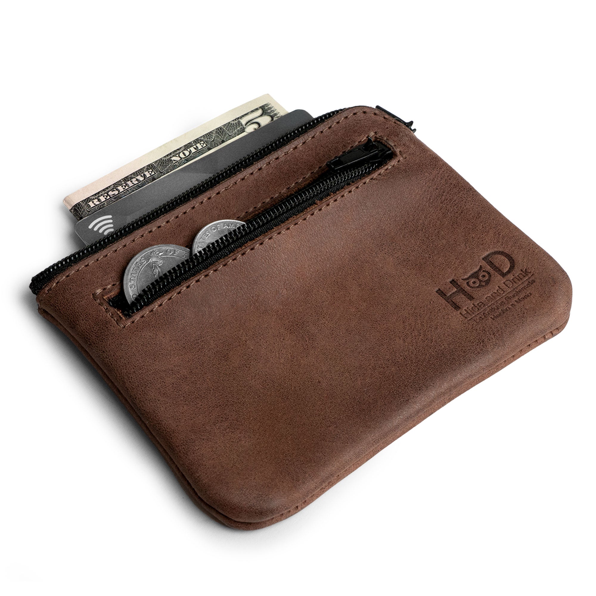 The Double Wallet Coin Pouch by Hide & Drink features a secure zipper closure, designed in Full Grain Leather with easy access for coins and bills. This stylish pouch showcases artisan craftsmanship through small batch production, being hand cut and hand sewn, with a unique fire branded touch, handmade in La Antigua Guatemala & Oaxaca Mexico.