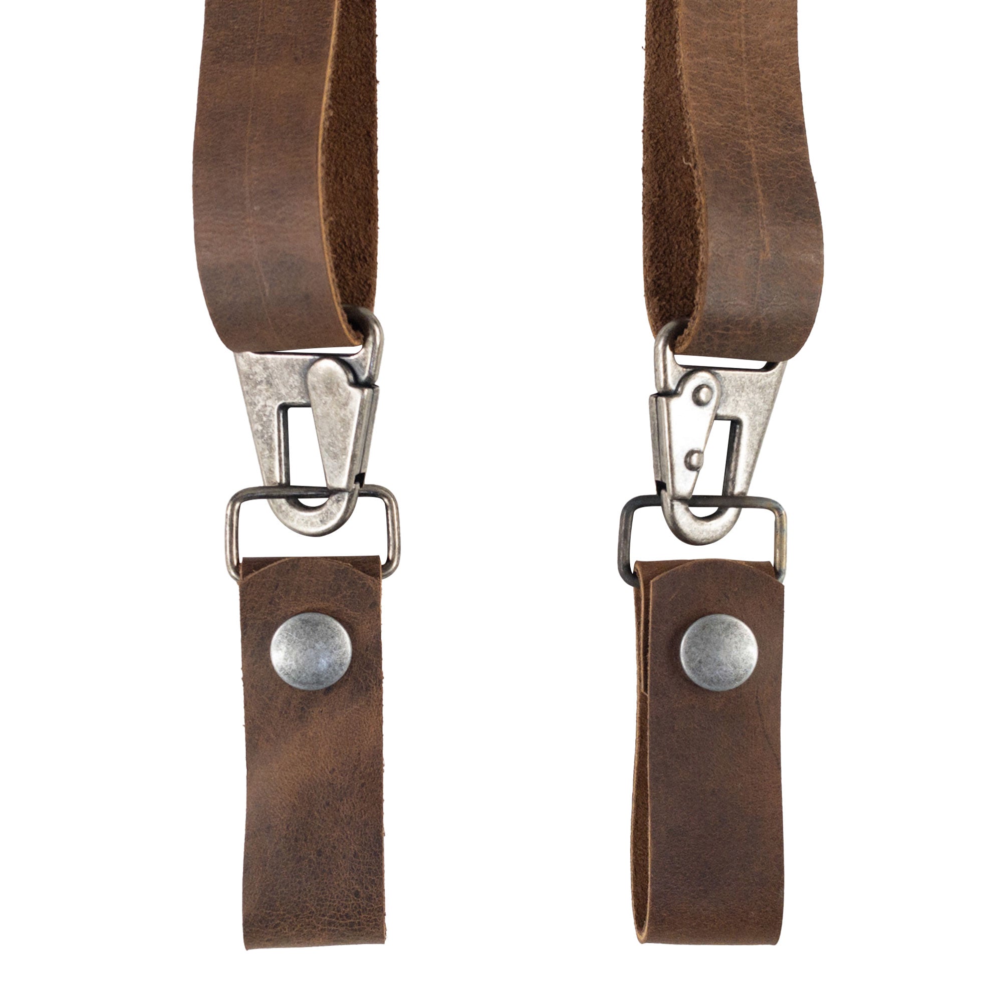 An angled shot of the Set of 2 Suspender Loop Attachments with Snap Closure by Hide & Groom, highlighting the sturdy clips and full grain leather. Set of 2 Suspender Loops Attachment for Men with Snap Closure, Heavy Duty, Wedding Accessories, Full Grain Leather, StockyardX, Small Batch Production, Hand Cut, Hand Sewn, Fire Branded, Artisan, Handmade in La Antigua Guatemala & Oaxaca Mexico.