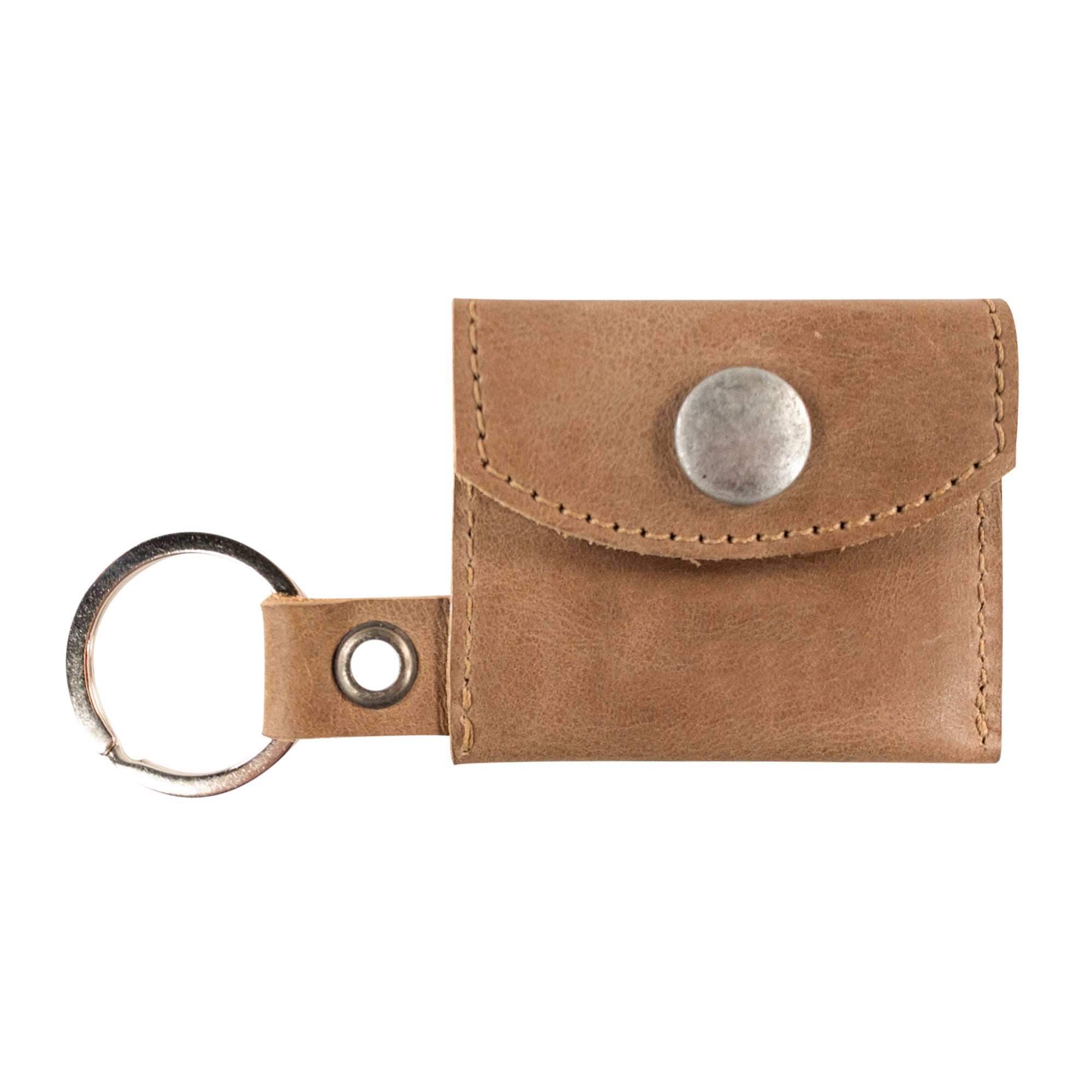 A vintage look of the Tiny Coin Holder Keychain by Hide & Drink, showcasing its ergonomic design made of Full Grain Leather. This piece exemplifies small batch production and the keen eye for artisan detail from La Antigua Guatemala.