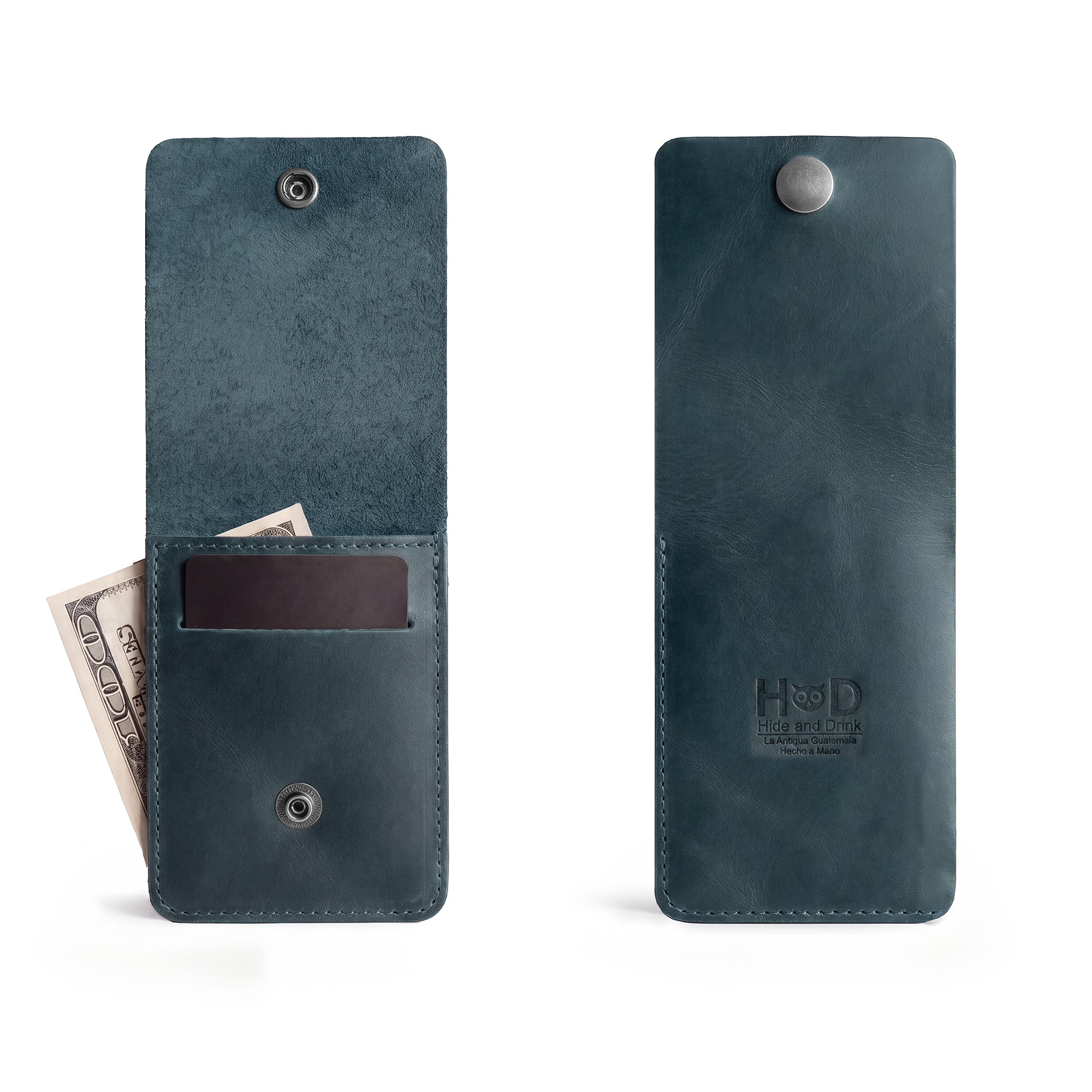 Side view of the blue Vertical Wallet by Hide & Drink illustrating its sleek design. This Vertical Front Pocket Wallet with Card Slot is designed for compact storage of bills and supports card holder functionality, made from high-quality full grain leather, emphasizing small batch production with hand cut and hand sewn features, fire branded for a unique flair. Handmade in La Antigua Guatemala & Oaxaca Mexico.