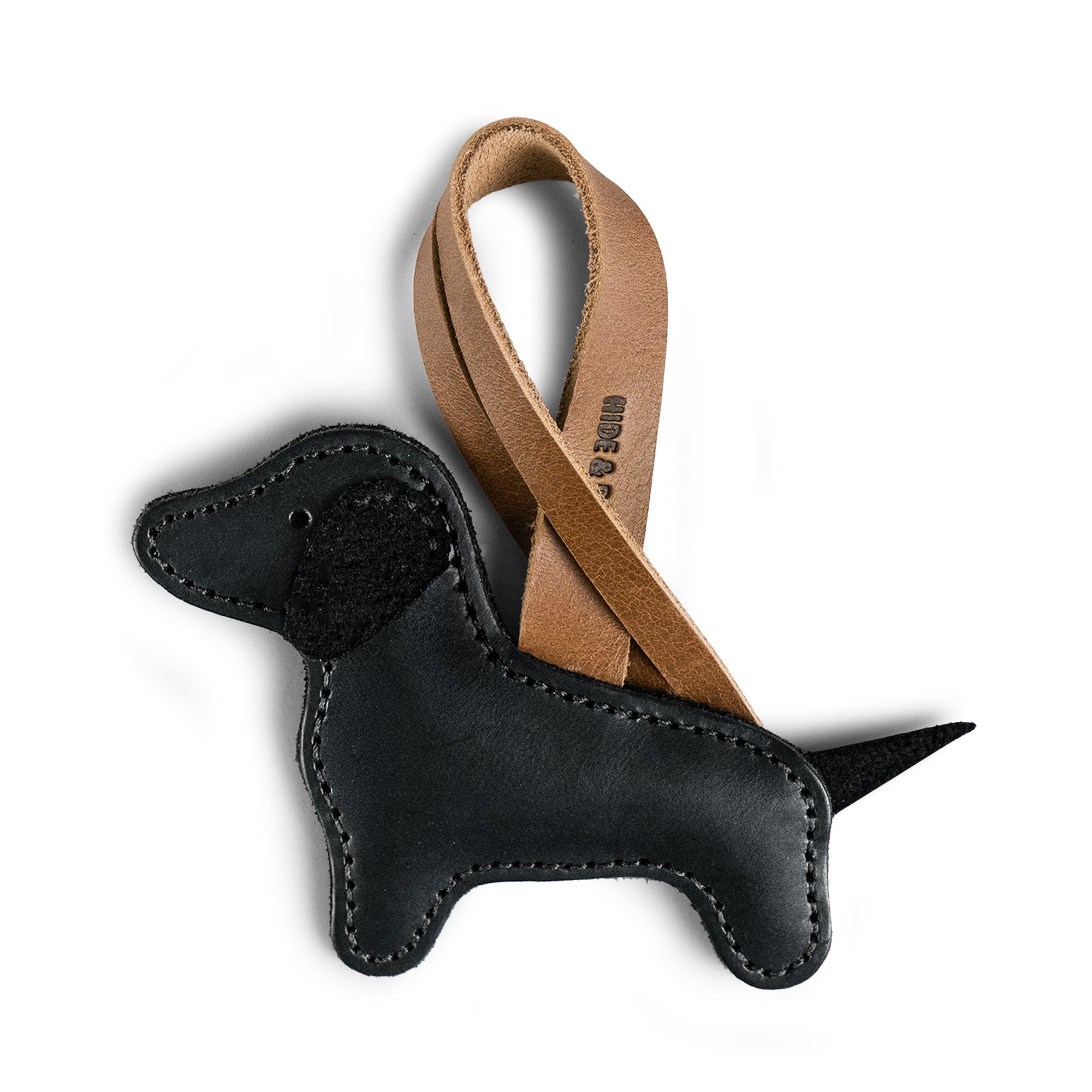 Stylish Dachshund Bag Charm from Hide & Drink designed for handbags and purses. This leather ornament showcases a Dachshund dog silhouette, crafted from full grain leather in small batch production. Perfect for women looking for unique accessories, the Dachshund Bag Charm combines artisan craftsmanship with a handmade touch from La Antigua, Guatemala and Oaxaca, Mexico.