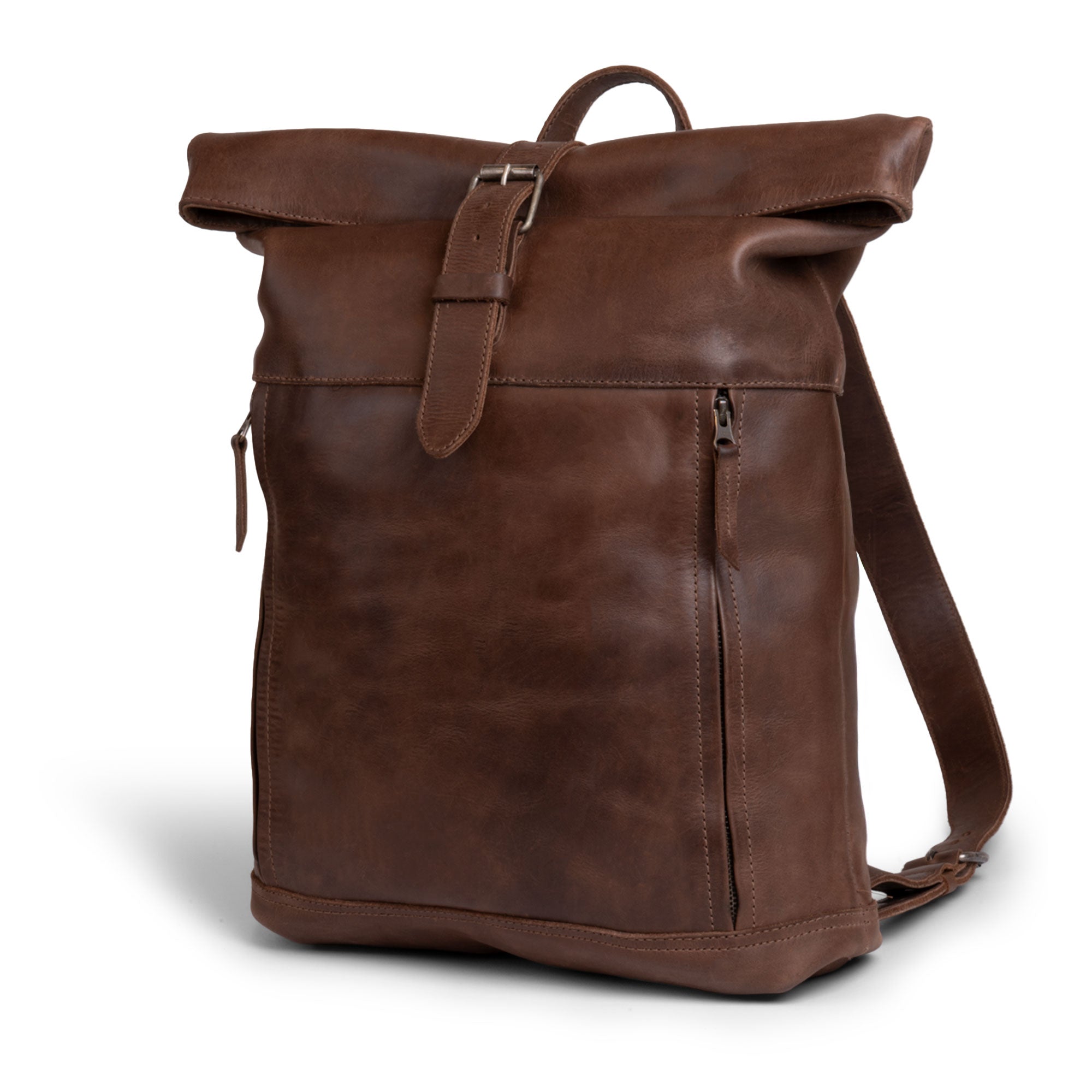 Side view of the Roll Top Backpack by Hide & Drink, showcasing its vintage style and durable full grain leather, equipped with adjustable shoulder straps, exemplifying handmade craftsmanship in La Antigua Guatemala.
