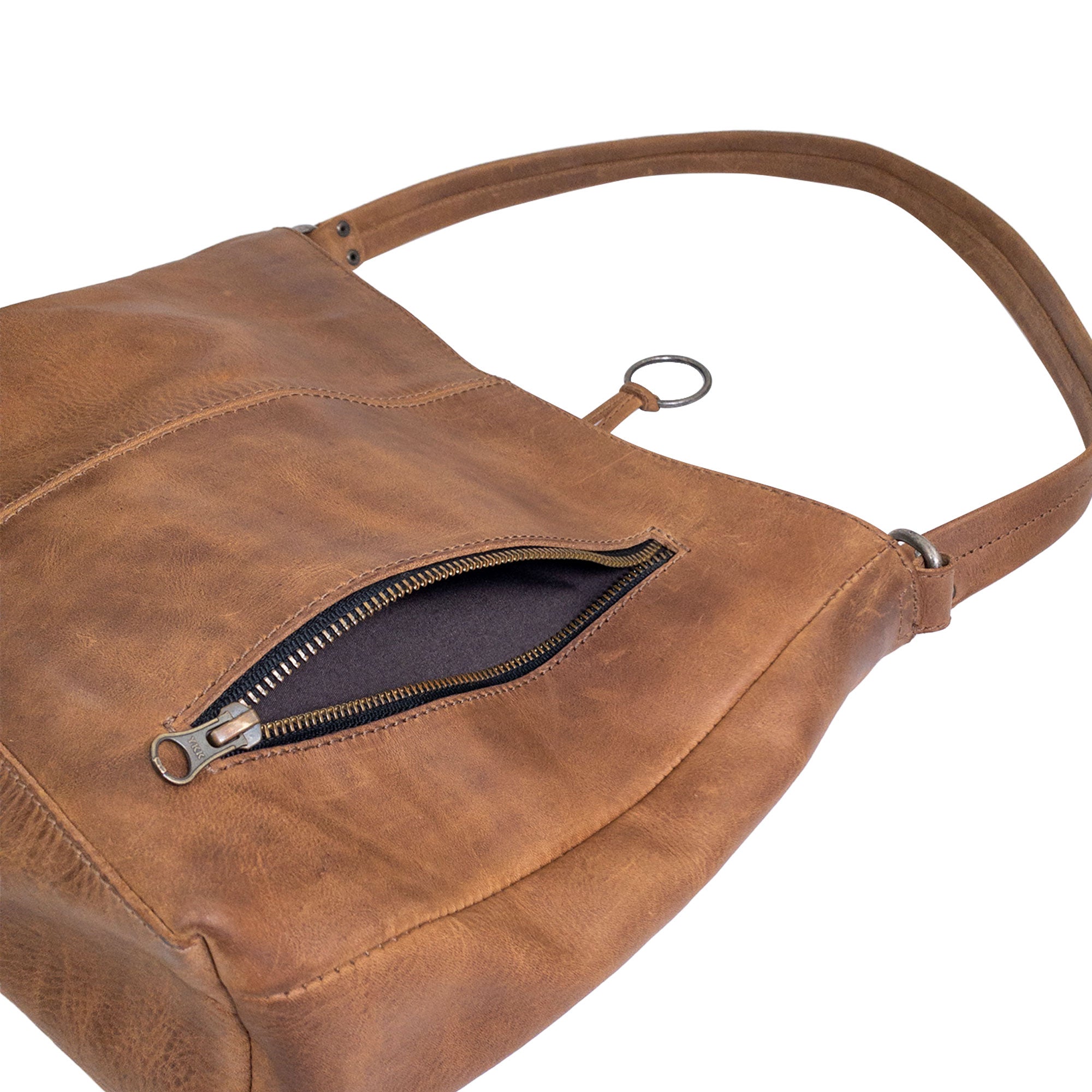 Close-up of the zippered pocket on the Classic Shoulder Bag by Hide & Drink, highlighting the secure storage option for essentials. This Classic Shoulder Bag combines Full Grain Leather & Plaid Cotton with artisan craftsmanship, ensuring durability and style for all occasions, handmade in La Antigua Guatemala & Oaxaca Mexico.
