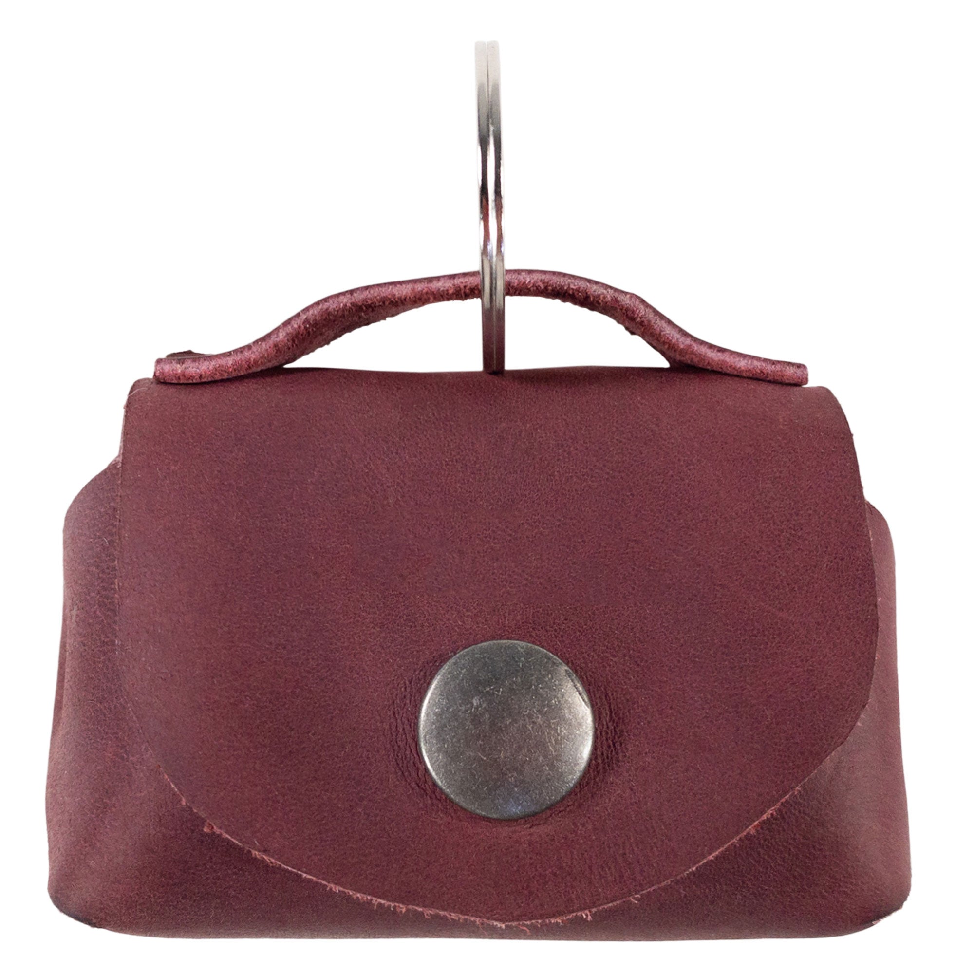 Showcasing the Tiny Handbag Keychain by Hide & Drink, featuring a durable Full Grain Leather design with a key ring holder. This artisanal piece signifies small batch production, showcasing hand cut and hand sewn craftsmanship from La Antigua Guatemala. Perfect for organizing your keys and coins.