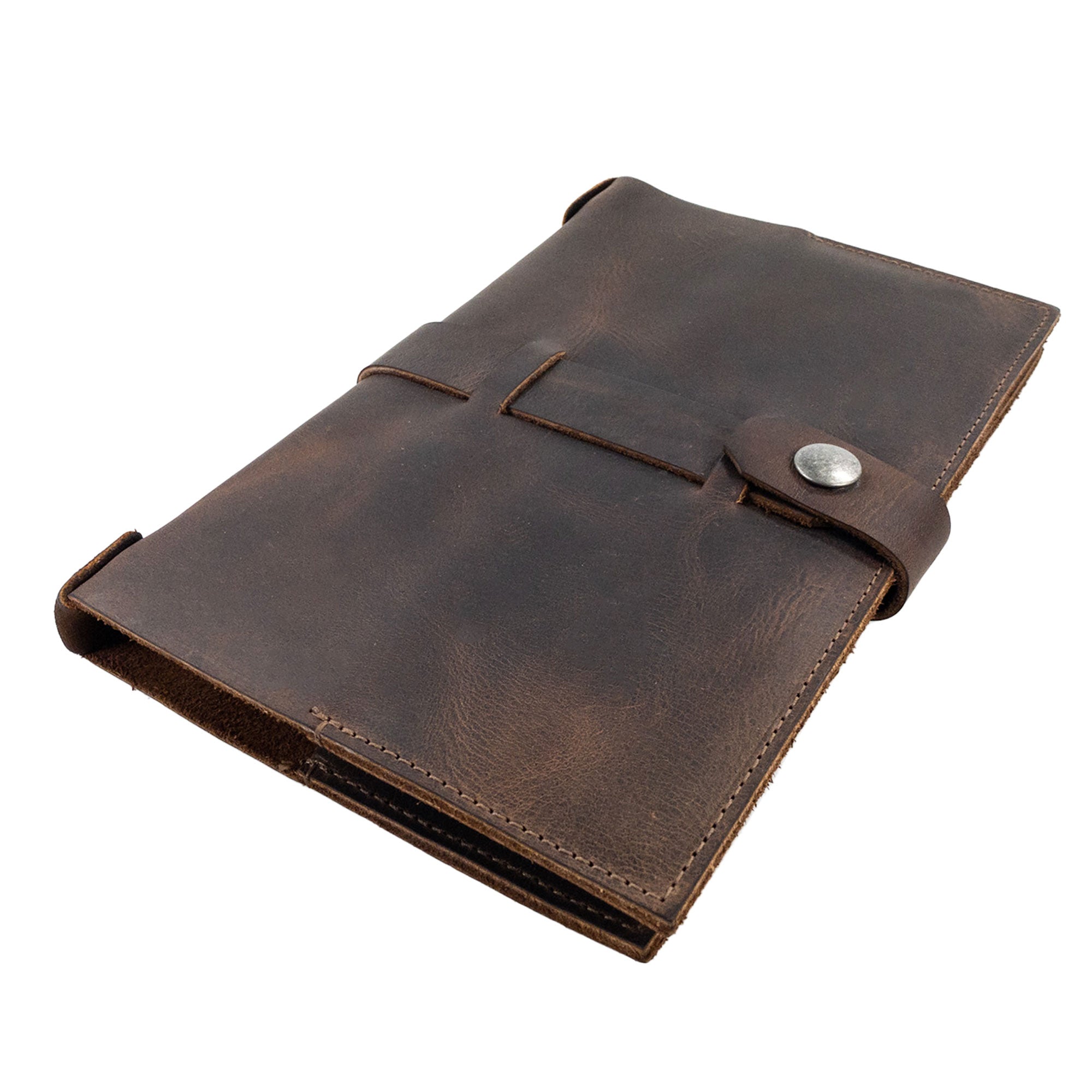 Sleek side view of the Riveted Field Note Cover for Moleskine (5 x 8.25 in.) Notebook NOT Included by Hide & Drink, showcasing its exquisite full grain leather and secure button closure. An ideal travel companion crafted through small batch production in La Antigua Guatemala & Oaxaca, Mexico.