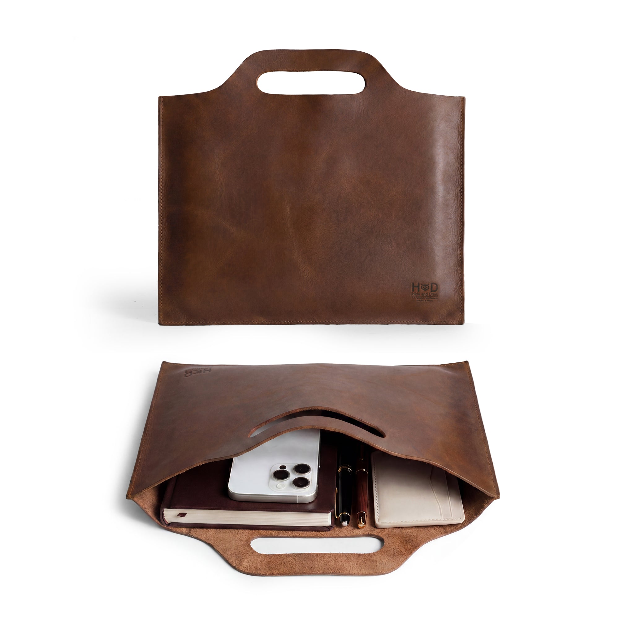 Flat Handbag by Hide & Drink in rich brown full grain leather, showcasing a simple and elegant design, perfect as a minimalist style carry-on bag, thin portfolio, or classic document holder. This travel accessory is crafted with care using small batch production and features hand cut and hand sewn details. Each piece is fire branded, highlighting its artisan quality, all handmade in La Antigua Guatemala & Oaxaca Mexico.
