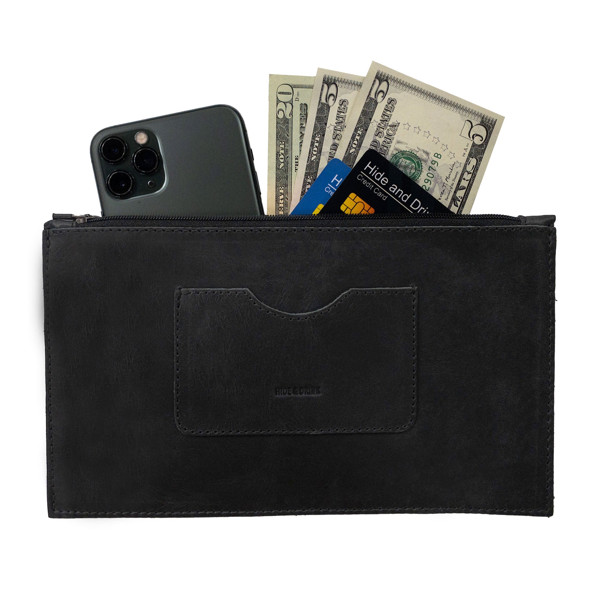 A sleek black rectangular zippered handbag by Hide & Drink, designed for women, featuring a card slot filled with cash and a smartphone. This female purse is made from full grain leather and reflects artisan crafting techniques showcasing small batch production, hand cut and sewn in La Antigua Guatemala & Oaxaca Mexico.