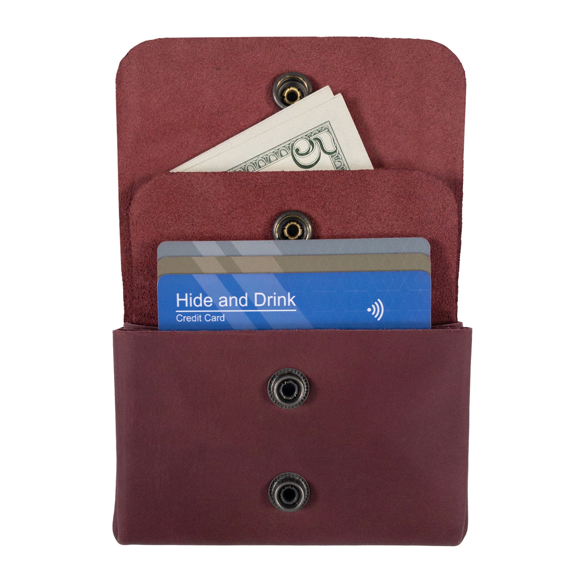 Open view of the burgundy Double Pouch Card Wallet by Hide & Drink with cash and cards inside. This Leather Double Pouch Card Wallet is a stylish choice for a card organizer, cash holder, or ID case for both men and women, made from Full Grain Leather in La Antigua Guatemala & Oaxaca Mexico.