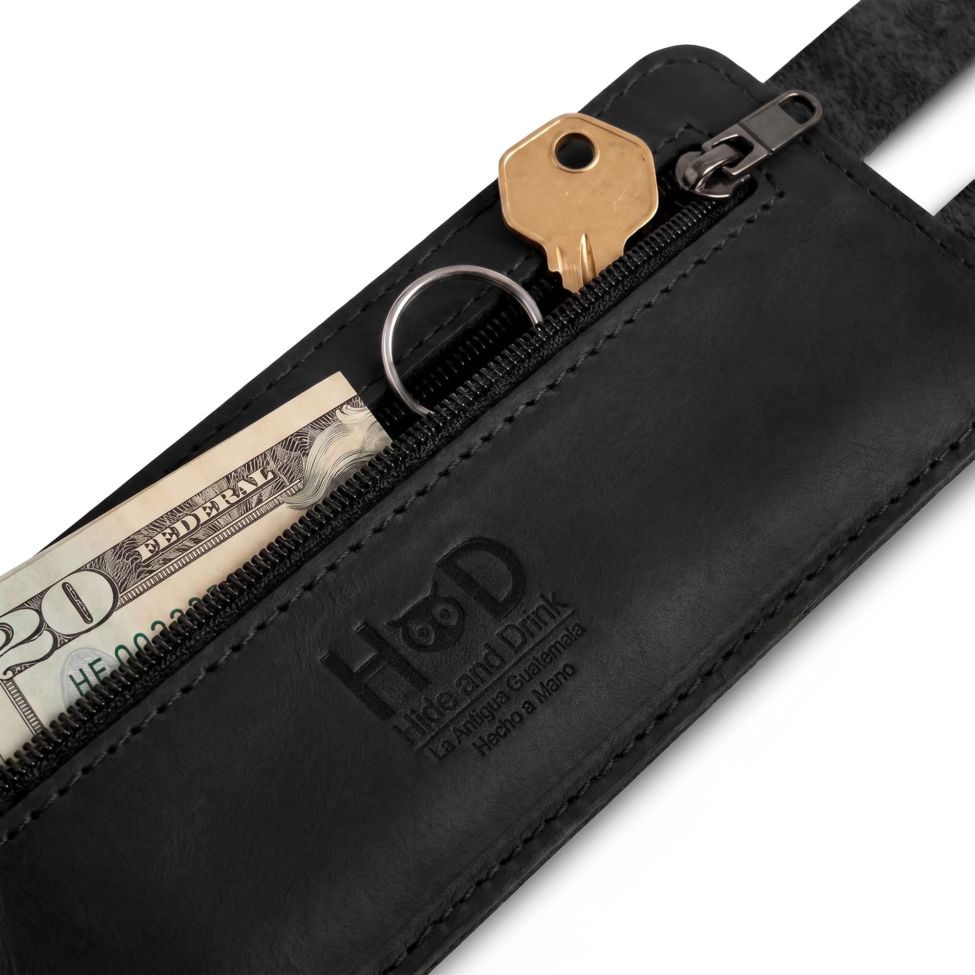 A detailed image shows Hide & Drink's Wrist-Wallet-Cuff showcasing its craftsmanship from Full Grain Leather. The hidden pouch for bills and inner zippered pouch highlight its practical yet stylish elements. This rustic leather bracelet is handmade in La Antigua Guatemala & Oaxaca Mexico, perfect for those seeking artisan quality.