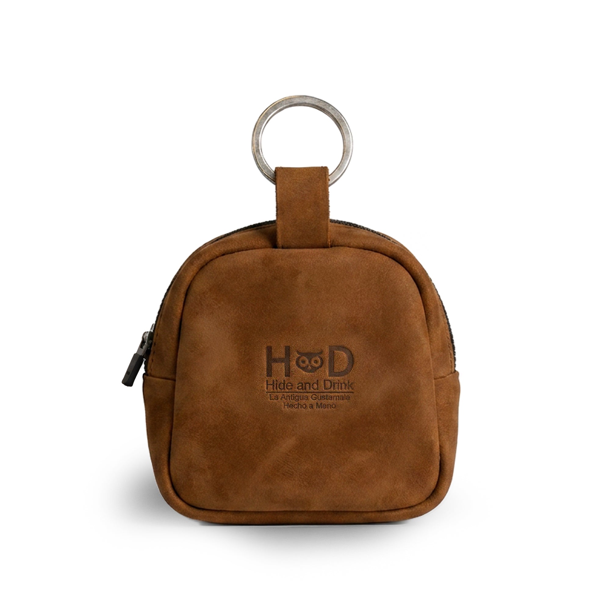 Showcasing the back view, The Pouty Pup Mini Pack by Hide & Drink features a sleek design in soft brown suede leather, making it a stylish choice for a mini backpack or wallet. This mini pouch is perfect for organizing cables or small items, crafted with care by artisans in La Antigua Guatemala & Oaxaca Mexico.