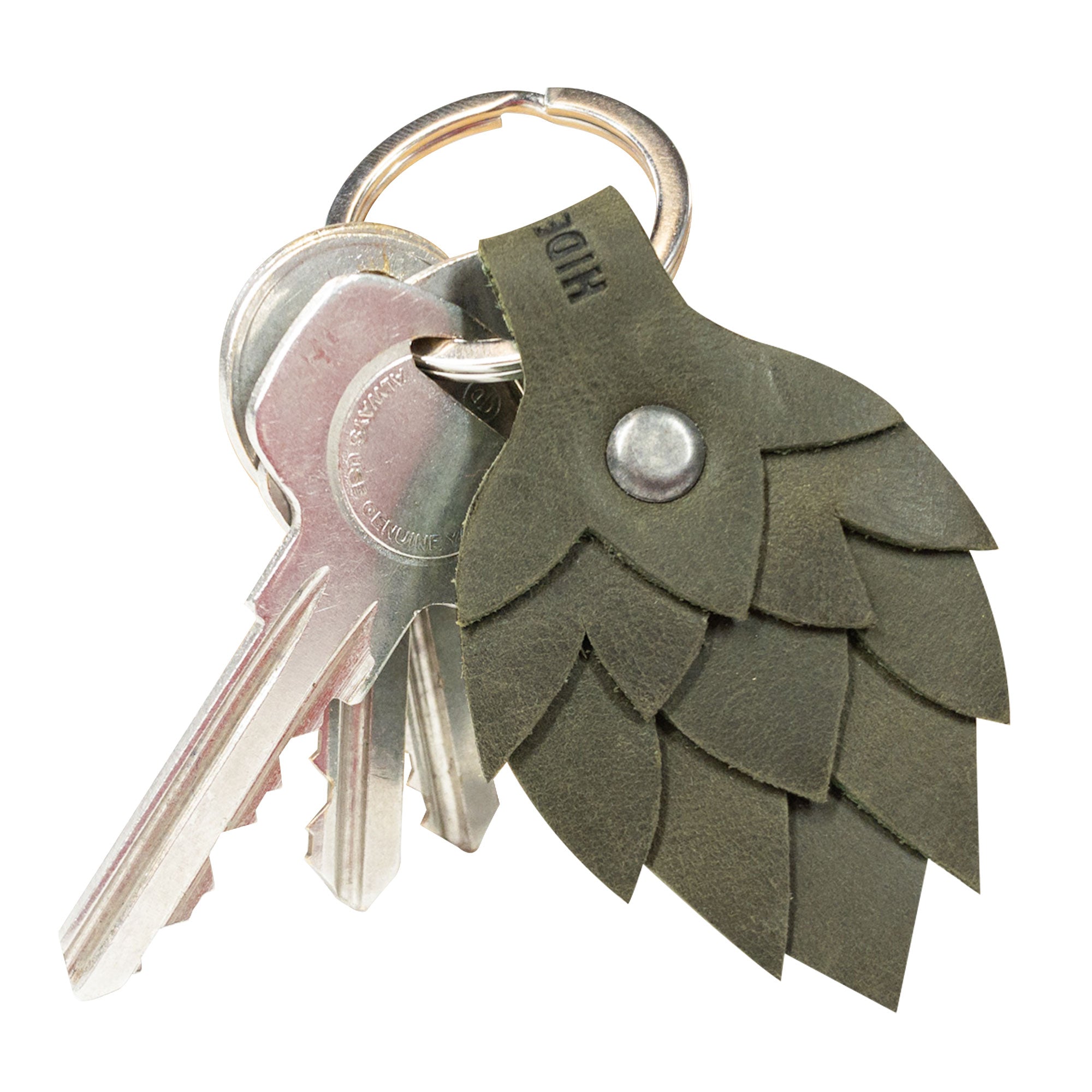 The Hop Flower Keychain by Hide & Drink, depicted with several keys attached, exemplifying a stylish accessory for beer enthusiasts. Crafted from Full Grain Leather, it highlights StockyardX’s commitment to small batch production with finely hand cut and hand sewn features, fire branded for a personal touch by artisans in La Antigua Guatemala & Oaxaca Mexico.