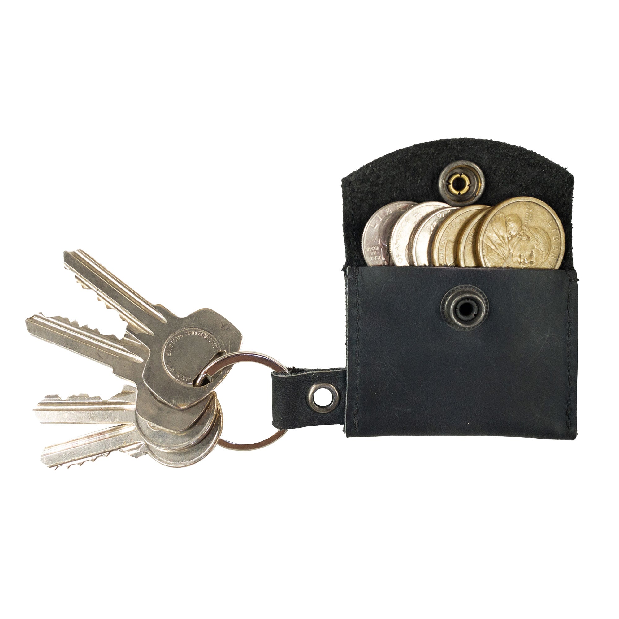 The interior of the Tiny Coin Holder Keychain by Hide & Drink, revealing its practical storage for coins. This Tiny Coin Holder, constructed from Full Grain Leather, is a result of small batch production and artisan handwork.