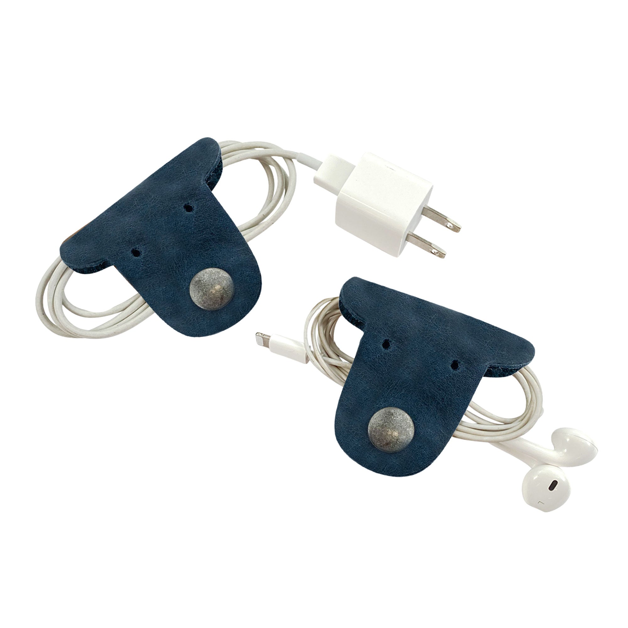 Manage your headphones and chargers in style with Taco Dog's navy blue Dog Cord Keepers. Crafted from premium full grain leather, these handmade accessories clip securely for effortless organization during travel. Experience artisan quality from La Antigua Guatemala with this 2 pack.