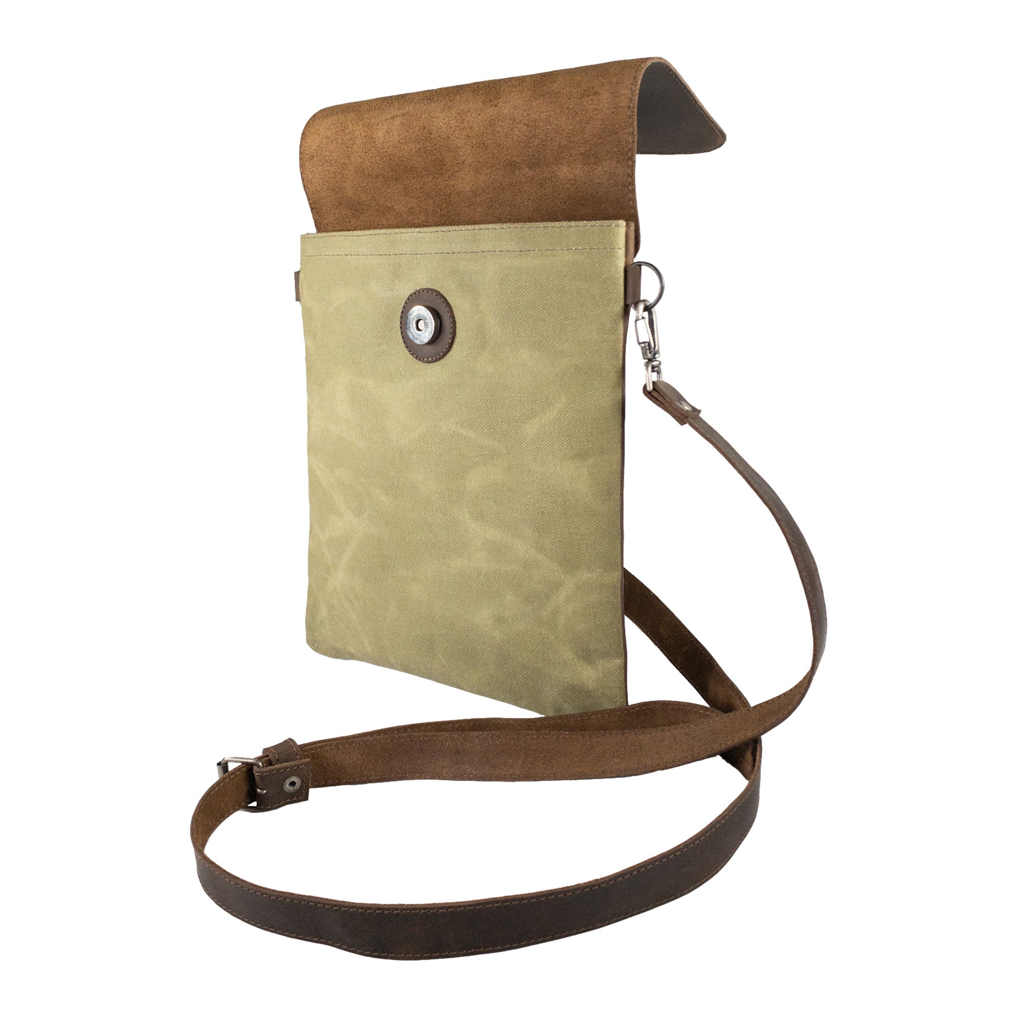 Hide & Drink Crossbody Bag displayed in a closed position, showcasing its sleek design and button closure. This Crossbody Bag with Adjustable Shoulder Strap is a Unisex Messenger Bag made from durable Full Grain Leather & Waxed Canvas, highlighting small batch production, hand cut, hand sewn, fire branded style, crafted by artisans in La Antigua Guatemala & Oaxaca Mexico.
