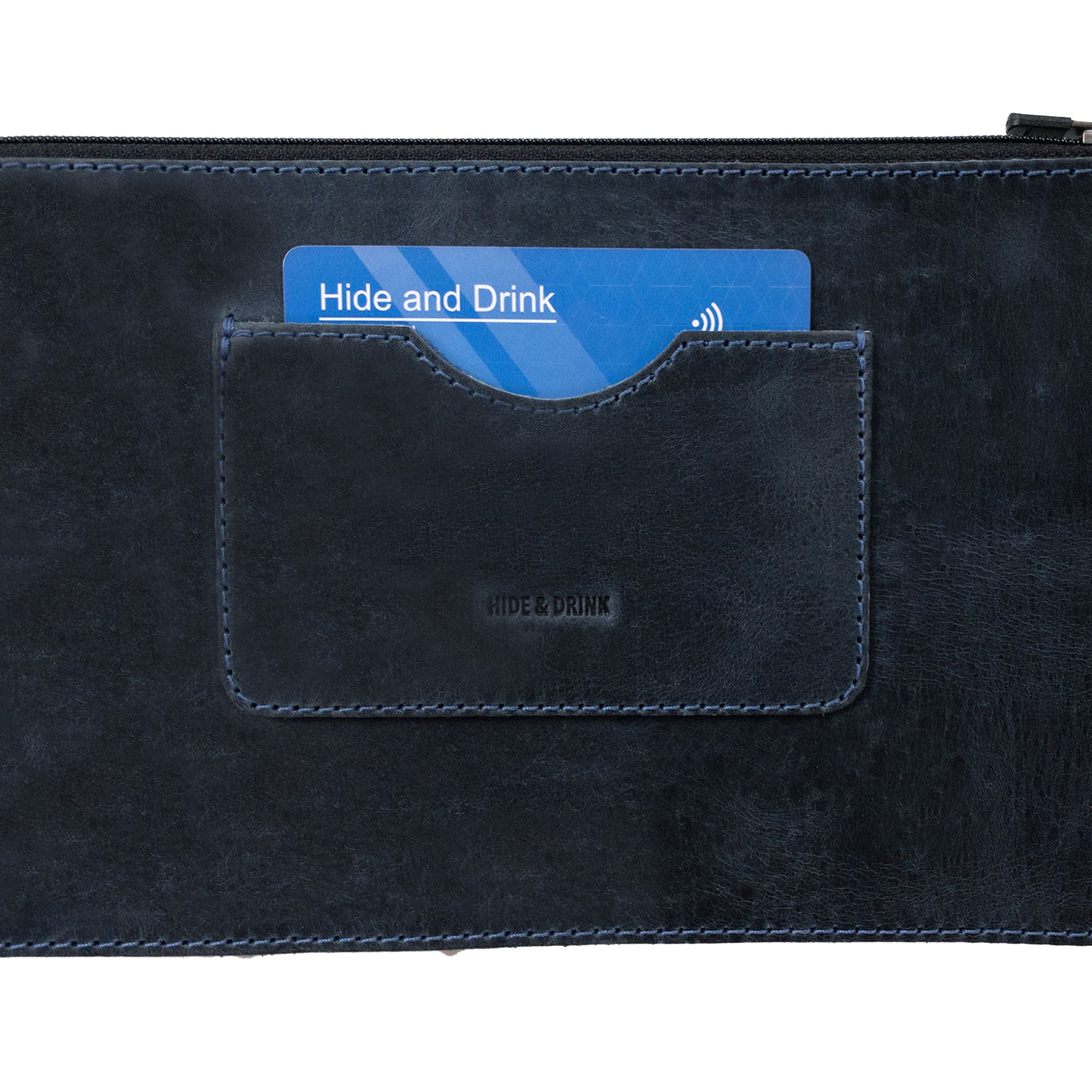 Close-up view of a dark brown rectangular zippered handbag by Hide & Drink featuring an organized card slot. This female purse is made from full grain leather to ensure durability, showcasing artisan techniques and small batch production, handcrafted in La Antigua Guatemala & Oaxaca Mexico.