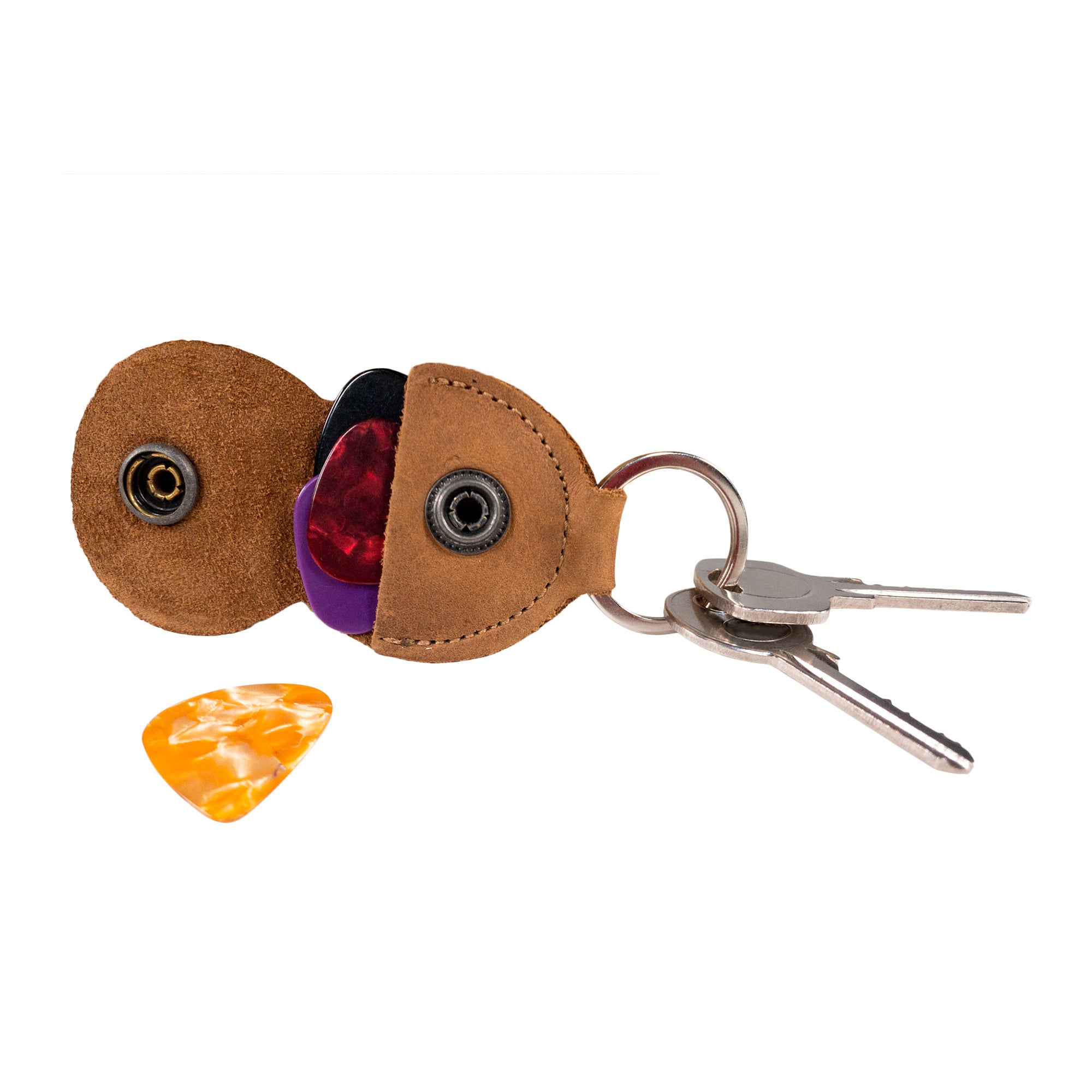 Presenting the Key Chain & Guitar Pick Holder by Hide & Drink, this image captures the holder alongside a vibrant guitar pick. As a Guitar Pick Holder with Ring, it excels as a key organizer for musicians. Made from durable Full Grain Leather, it showcases the small batch production ethos of StockyardX. Hand cut, hand sewn, and fire branded, this artisan creation is handmade in La Antigua Guatemala & Oaxaca Mexico.