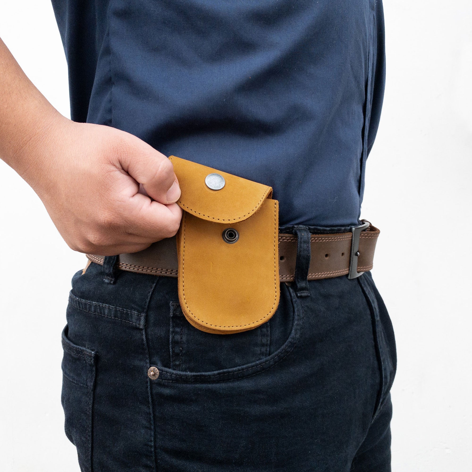 Dimensions of the Bright Yellow Holster Pouch by Hide & Drink, demonstrating its compact and convenient design. Handmade from full grain leather, this artisan pouch is ideal for storing small personal items.