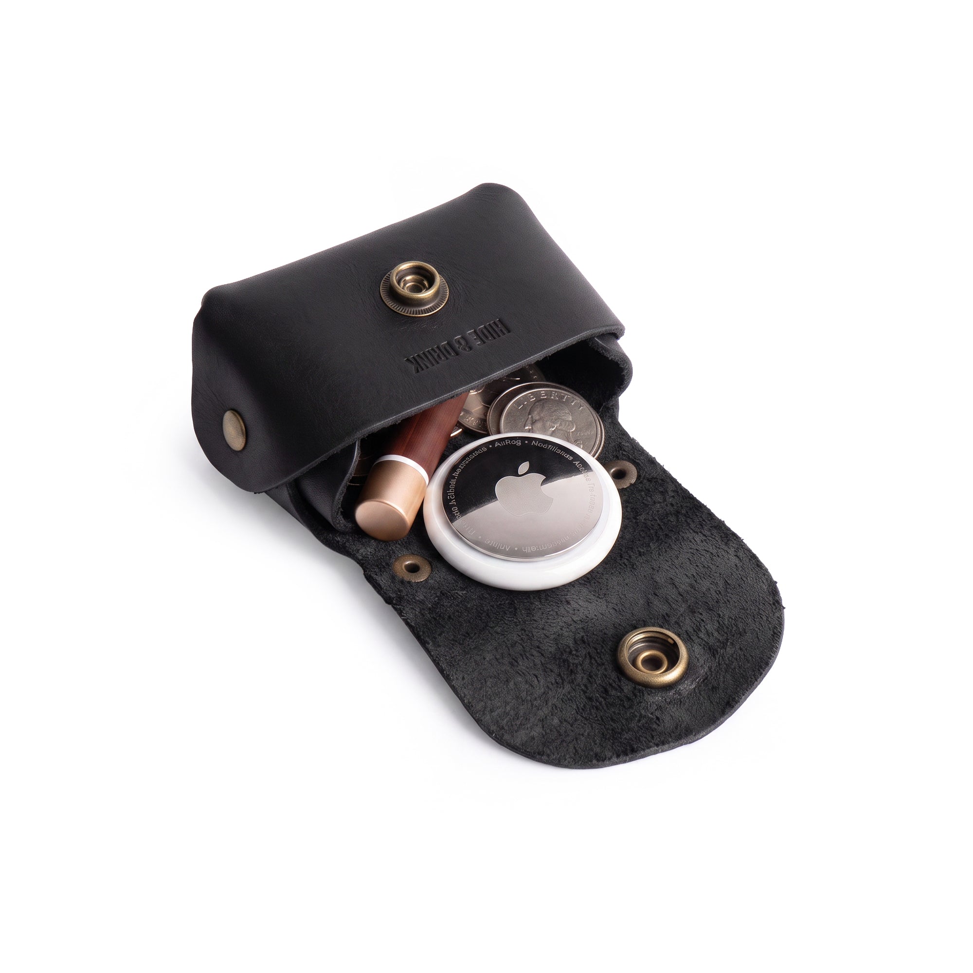 Interior view of the black Tiny Handbag Keychain by Hide & Drink, displaying keys and coins. Crafted from Full Grain Leather, this artisanal product represents small batch production and showcases excellent hand cut and hand sewn craftsmanship.