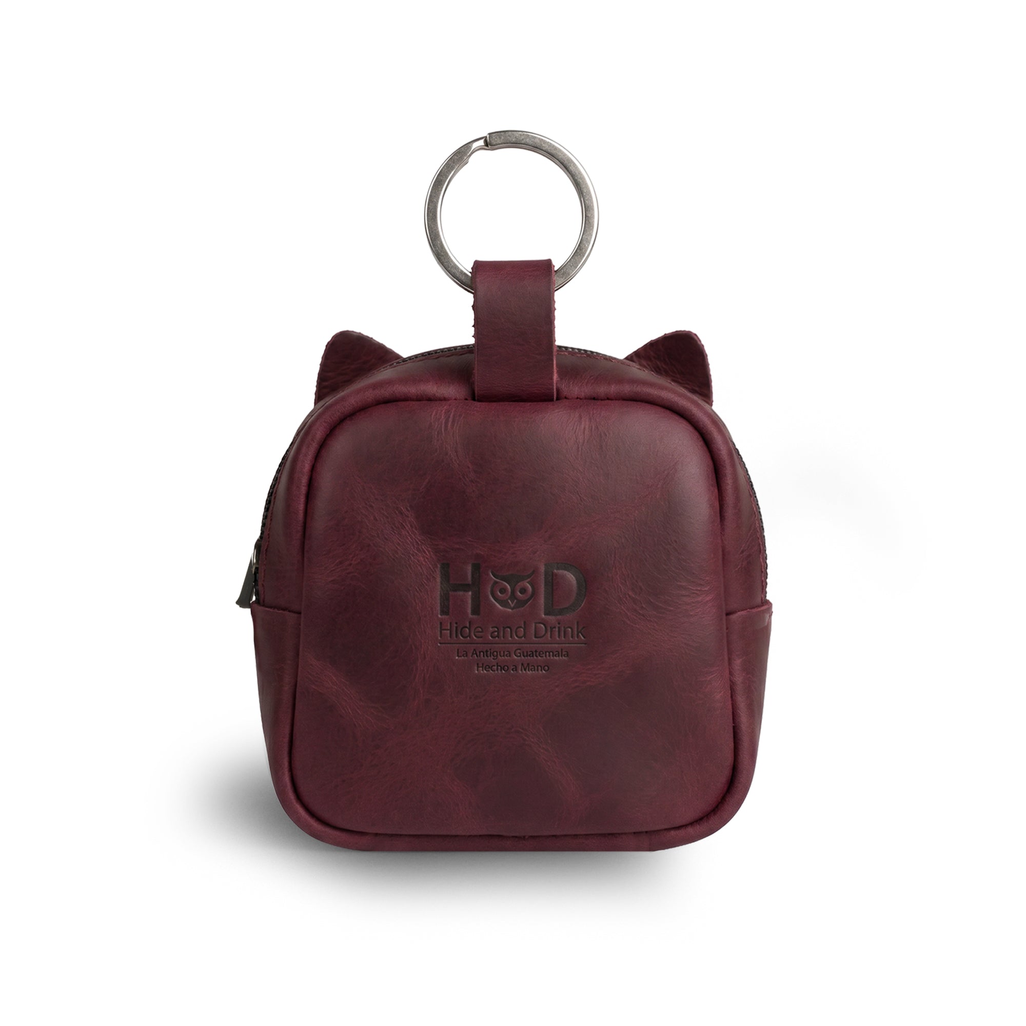 The back view of the Cheery Cat Mini Pack by Hide & Drink highlights its cute cat ears and sturdy keychain loop. Perfect as a cable pouch or SD card holder, it exemplifies handmade quality with Full Grain Leather, supporting artisan production in La Antigua Guatemala & Oaxaca, Mexico.