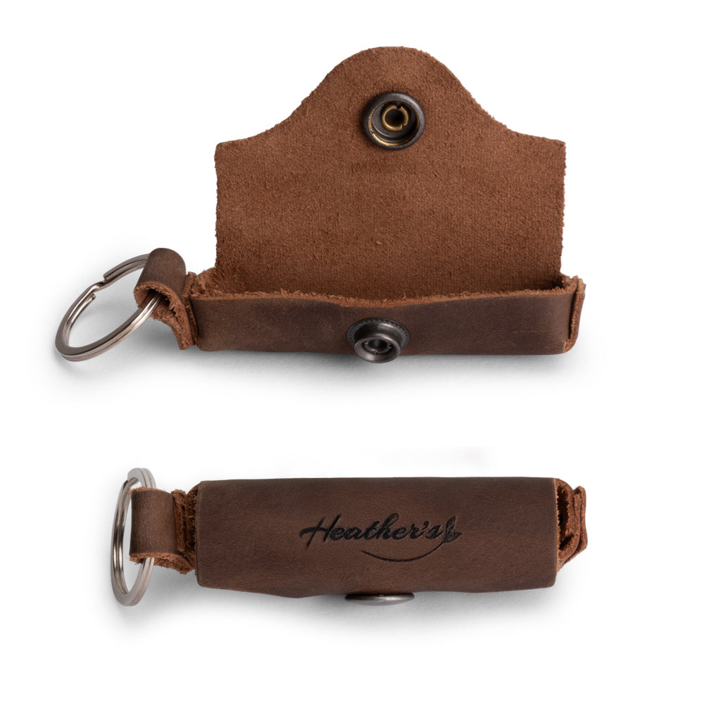 Heather's Lip Balm Keychain - An elegant closed Lip Balm Keychain crafted from Full Grain Leather, featuring a stylish snap closure. This travel-friendly lip balm holder is perfect for protecting lips while on the move, making it a great gift option for those who appreciate artisan work. Handmade in La Antigua Guatemala with excellent craftsmanship.