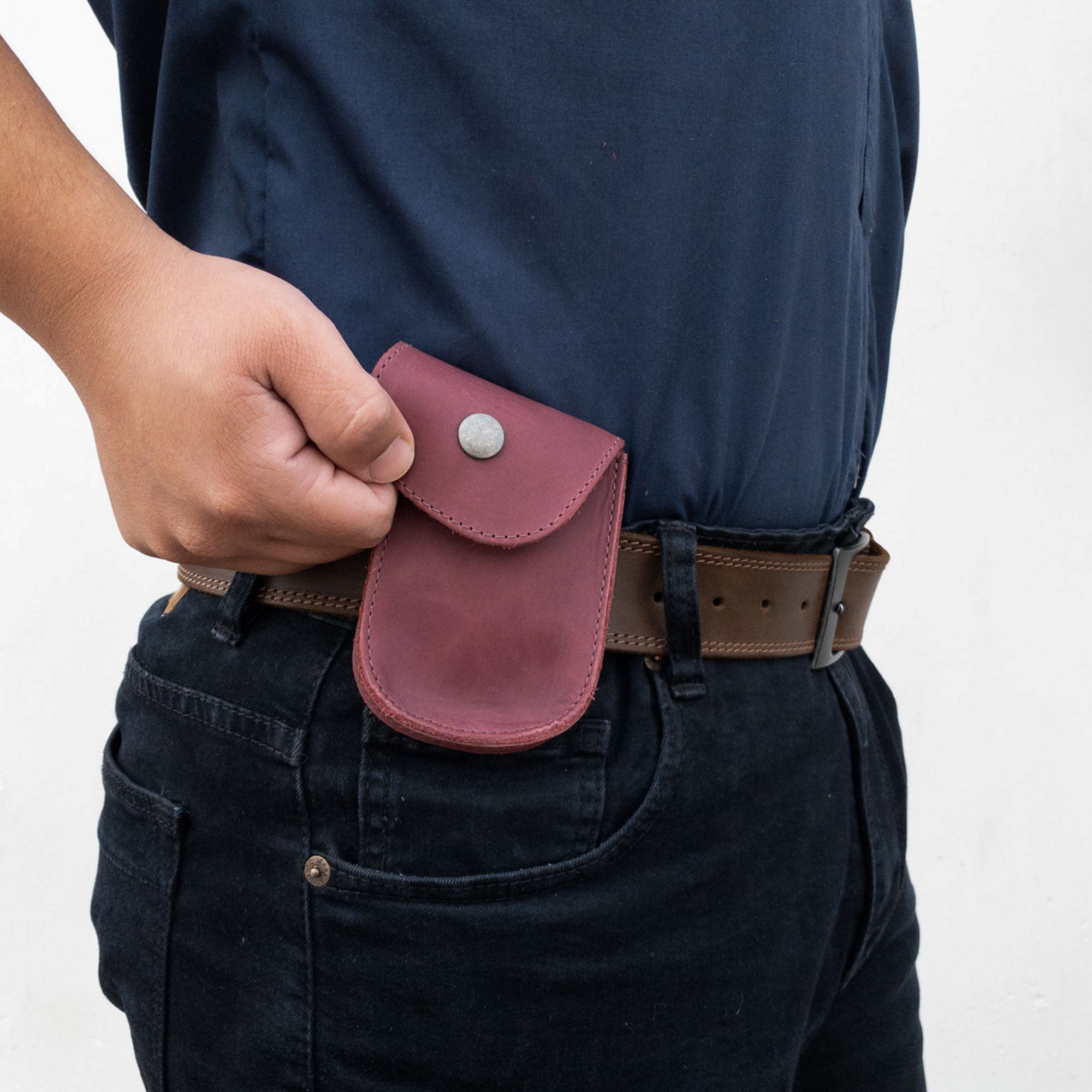 Front view of the Burgundy Holster Pouch by Hide & Drink, depicting its elegant design and artisan quality. Made from full grain leather, this durable pouch is great for coins, cards, and everyday items.