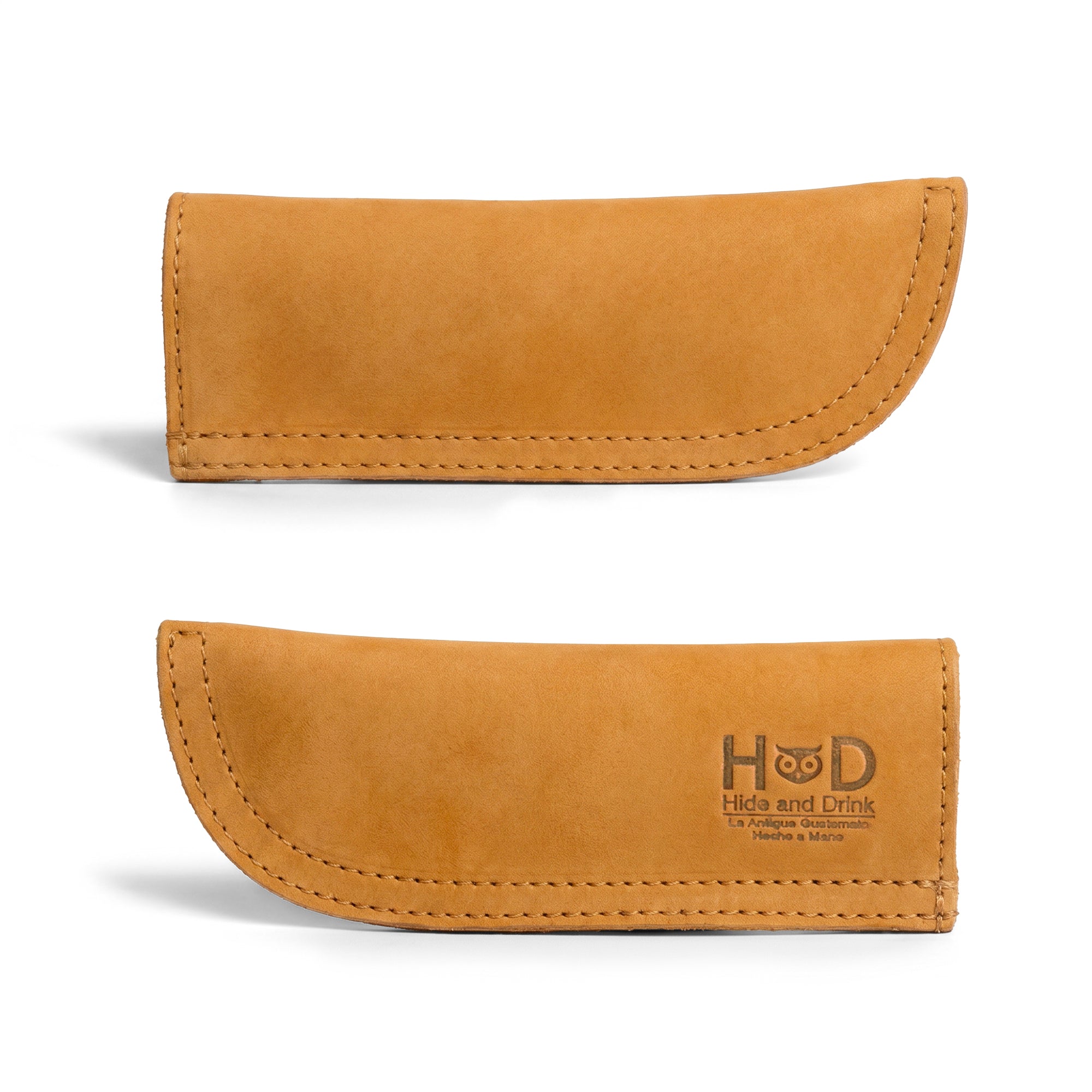 Hide & Drink Cast Iron Panhandle Cover featured with its packaging, emphasizing quality craftsmanship. This hot handle protector is made from full grain leather and showcases artisan precision through its double stitched design. Handmade in La Antigua Guatemala & Oaxaca Mexico, it's a stylish addition to any kitchen gear.
