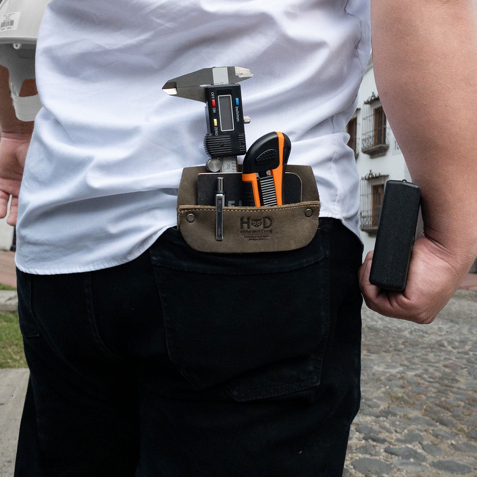 Hide & Drink Leather Work Pocket presented in a natural background, embodying its artisanal roots. Crafted from Full Grain Leather, it stands out as a must-have for quick grab access to essentials.