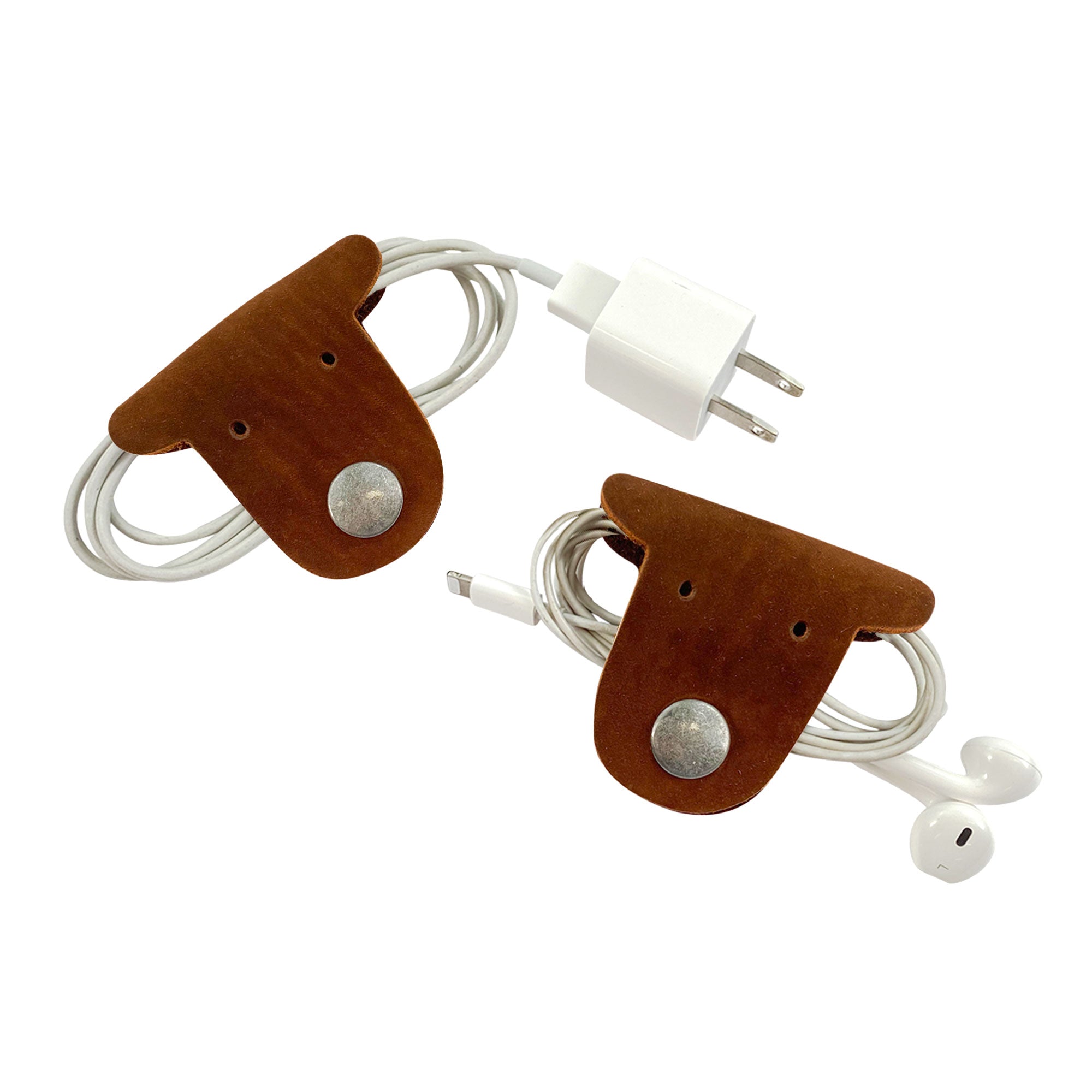Wrap your cords in style with Taco Dog's brown Dog Cord Keepers, perfect for managing headphones and chargers. Designed from full grain leather, these handmade accessories offer both functionality and charm for travel. Enjoy artisanal quality from La Antigua Guatemala with this duo.