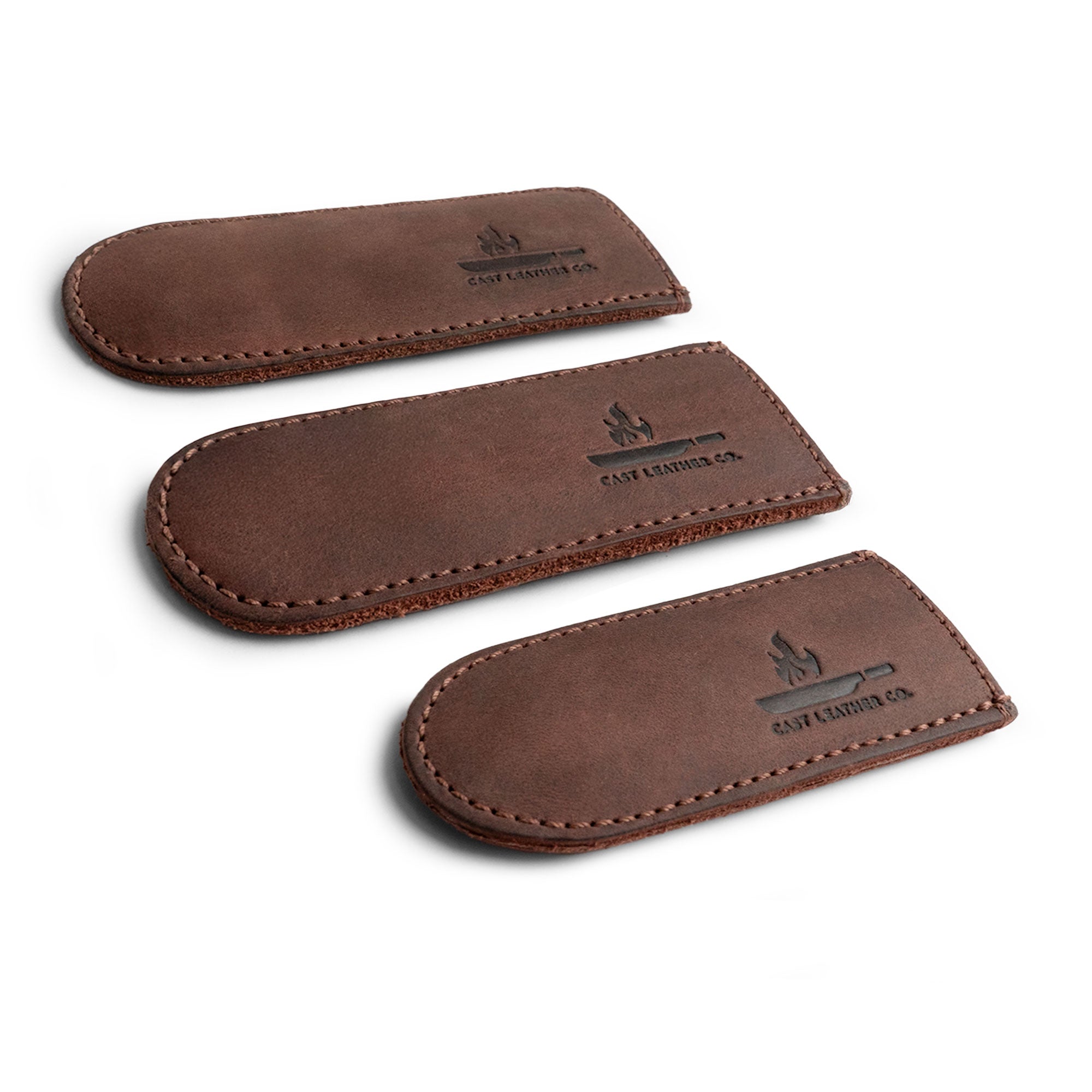 An elegant display of Cast Leather Co.'s Hot Handle Covers (Set of 3), showcasing full grain leather construction for optimal heat resistance. Perfect for cast iron skillets, these handmade skillet handle covers combine style and functionality, embodying small batch production craftsmanship.