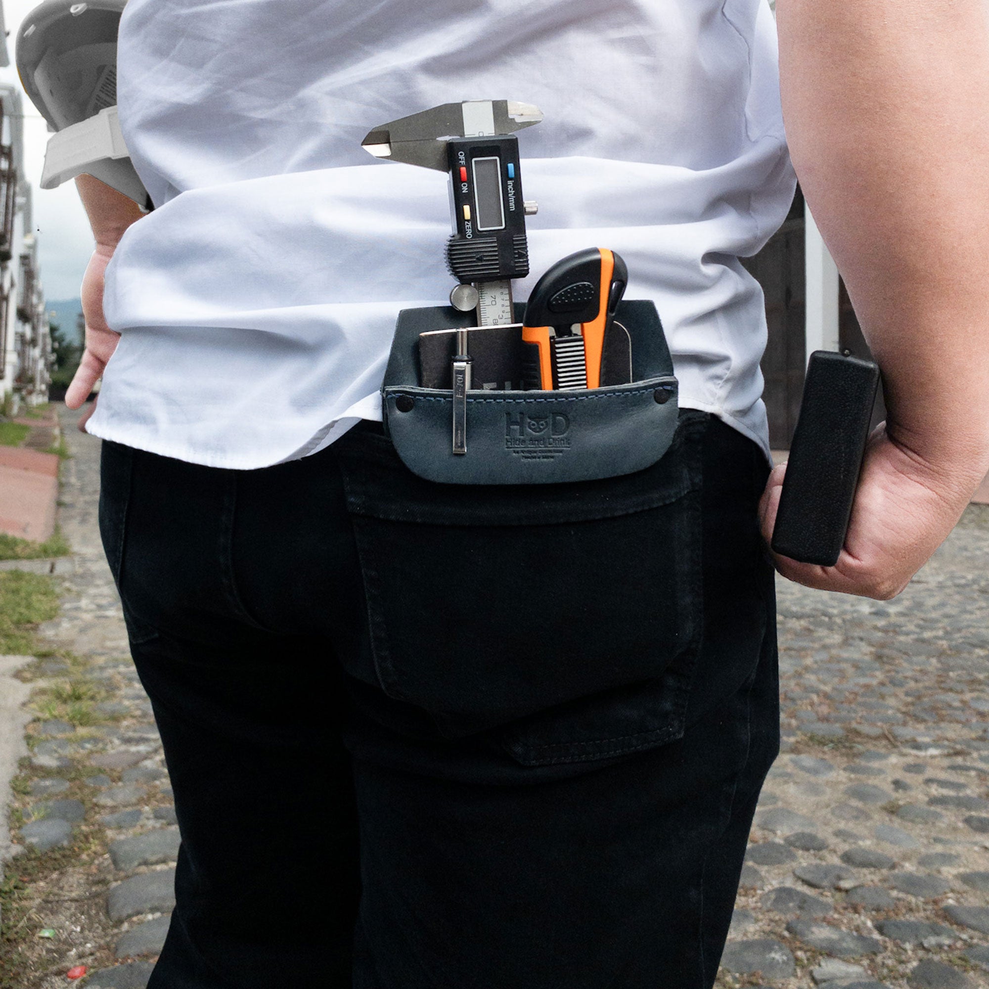 Hide & Drink Leather Work Pocket in a flat position, emphasizing its minimalist design. This Leather Work Pocket, made from Full Grain Leather, is ideal for organizing tools and pens on the go.