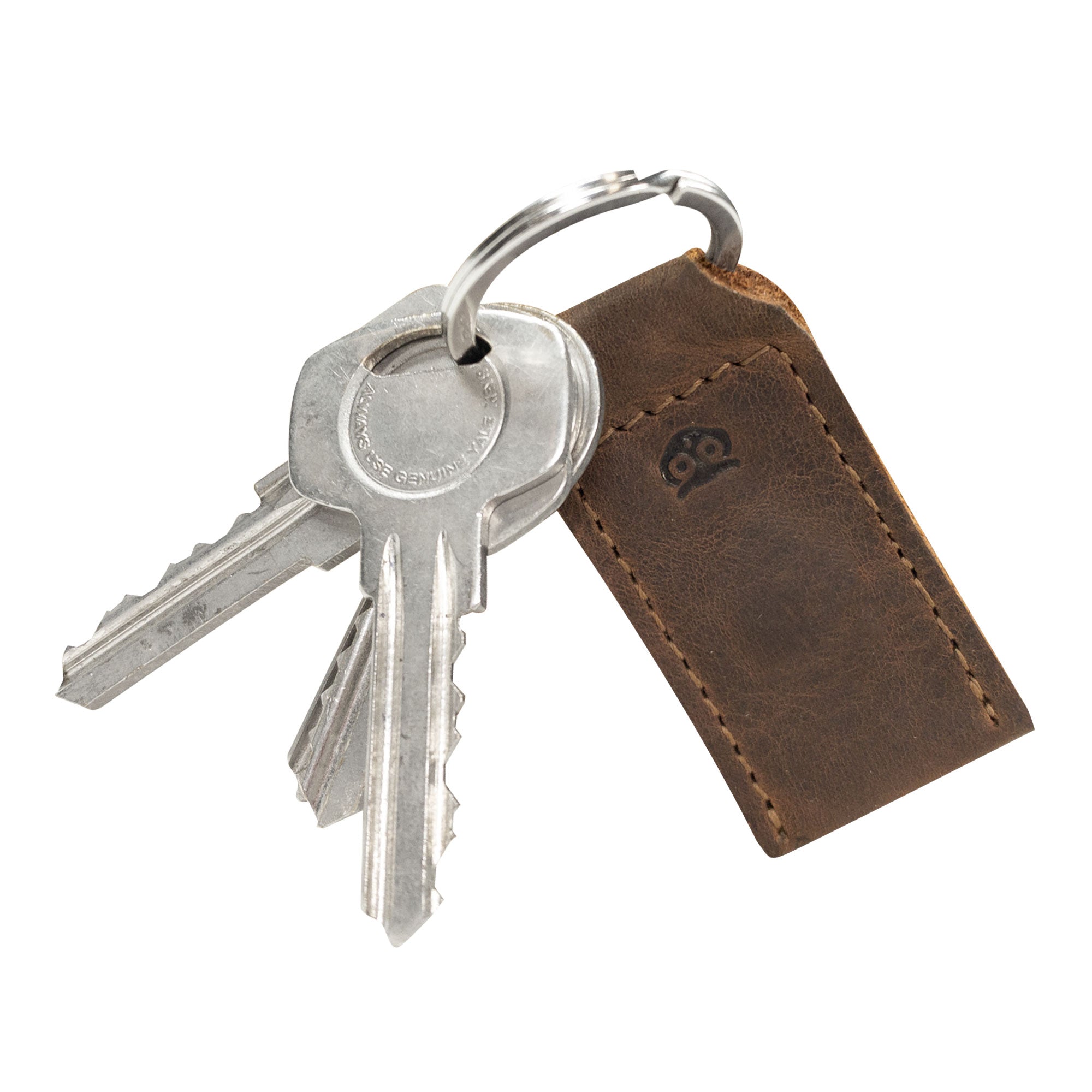 Close-up of keys attached to the Magnetic Keychain Holder by Hide & Drink, featuring a stylish leather keyring. This key organizer is perfect for keeping essentials secure while adding a touch of elegance with its full grain leather design. Hand cut and hand sewn, showcasing artisan craftsmanship in La Antigua Guatemala & Oaxaca Mexico.