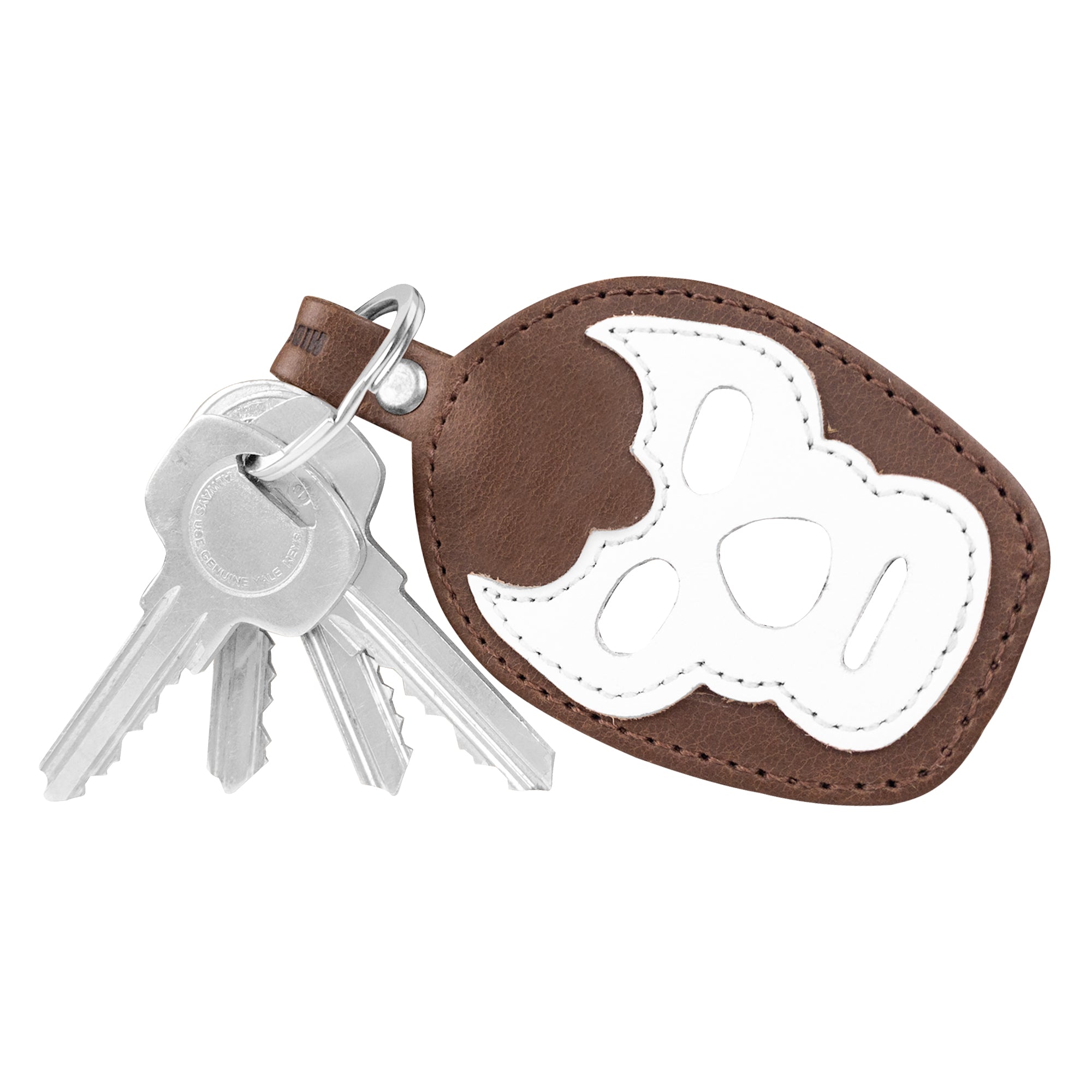 A side view of the Luchador Mask Leather Keychain highlighting its durable construction. This keyring by Hide & Drink is crafted from high-quality full grain leather, perfect as a key organizer and travel accessory. Each piece showcases small batch production, handmade by artisans in La Antigua Guatemala and Oaxaca Mexico.