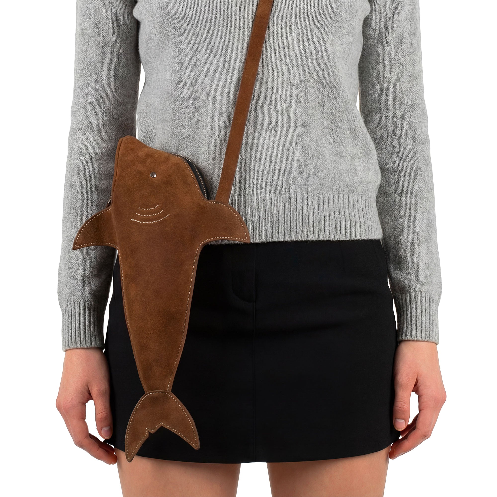 Chic Shark-Shaped Shoulder Bag from Tudi Frudi designed for a trendy look. Crafted from premium Full Grain Leather, this bag features an adjustable strap, allowing it to be worn as a crossbody or messenger bag. Handmade in La Antigua Guatemala, the bag represents small batch production and artisan craftsmanship, making it both stylish and functional.