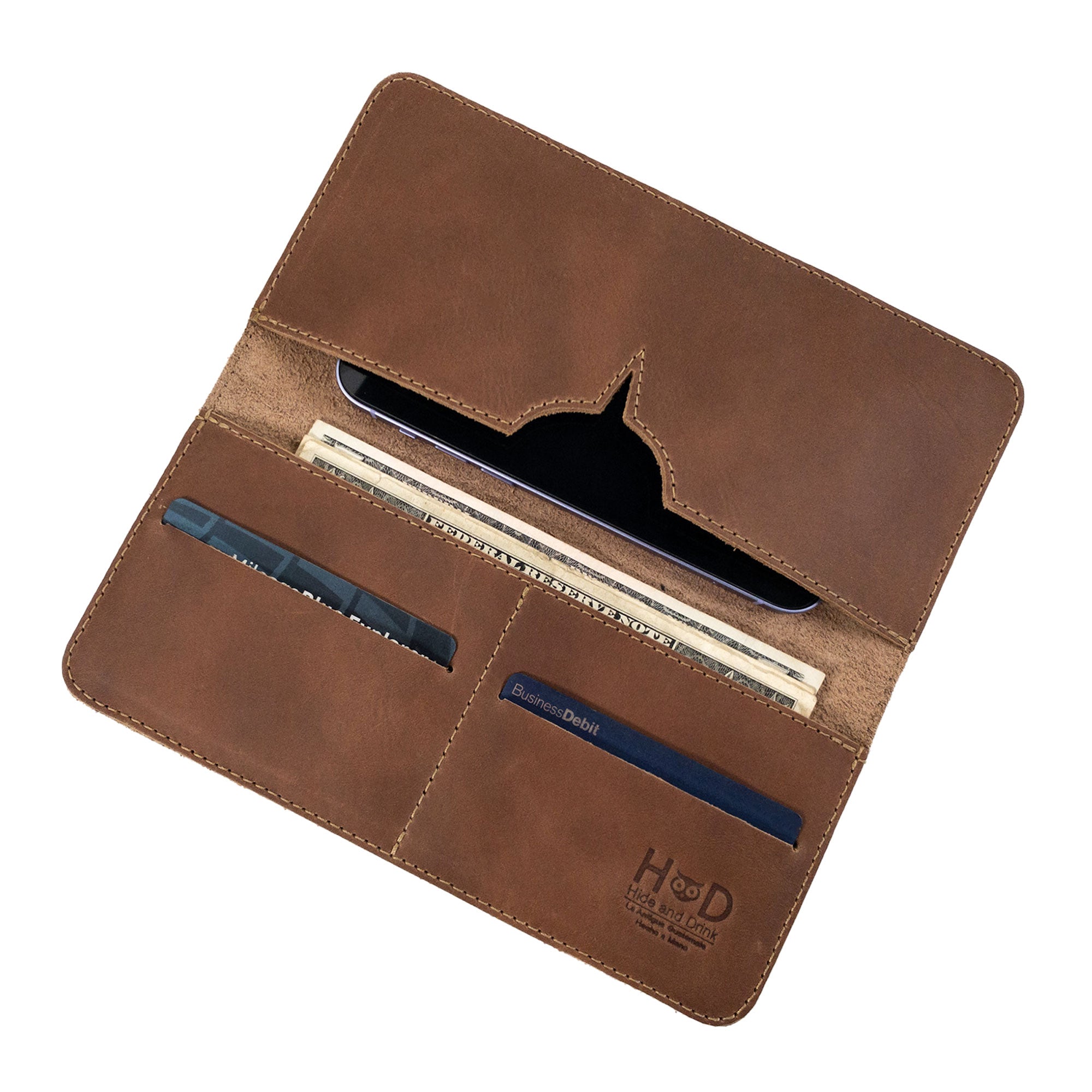 Detailed interior view of the rustic bifold wallet for cellphone by Hide & Drink, designed for effective organization. This Bifold Wallet for Cellphone, constructed from Full Grain Leather, merges functionality with artistic flair. Proudly made in small batches by artisans in La Antigua Guatemala & Oaxaca Mexico.