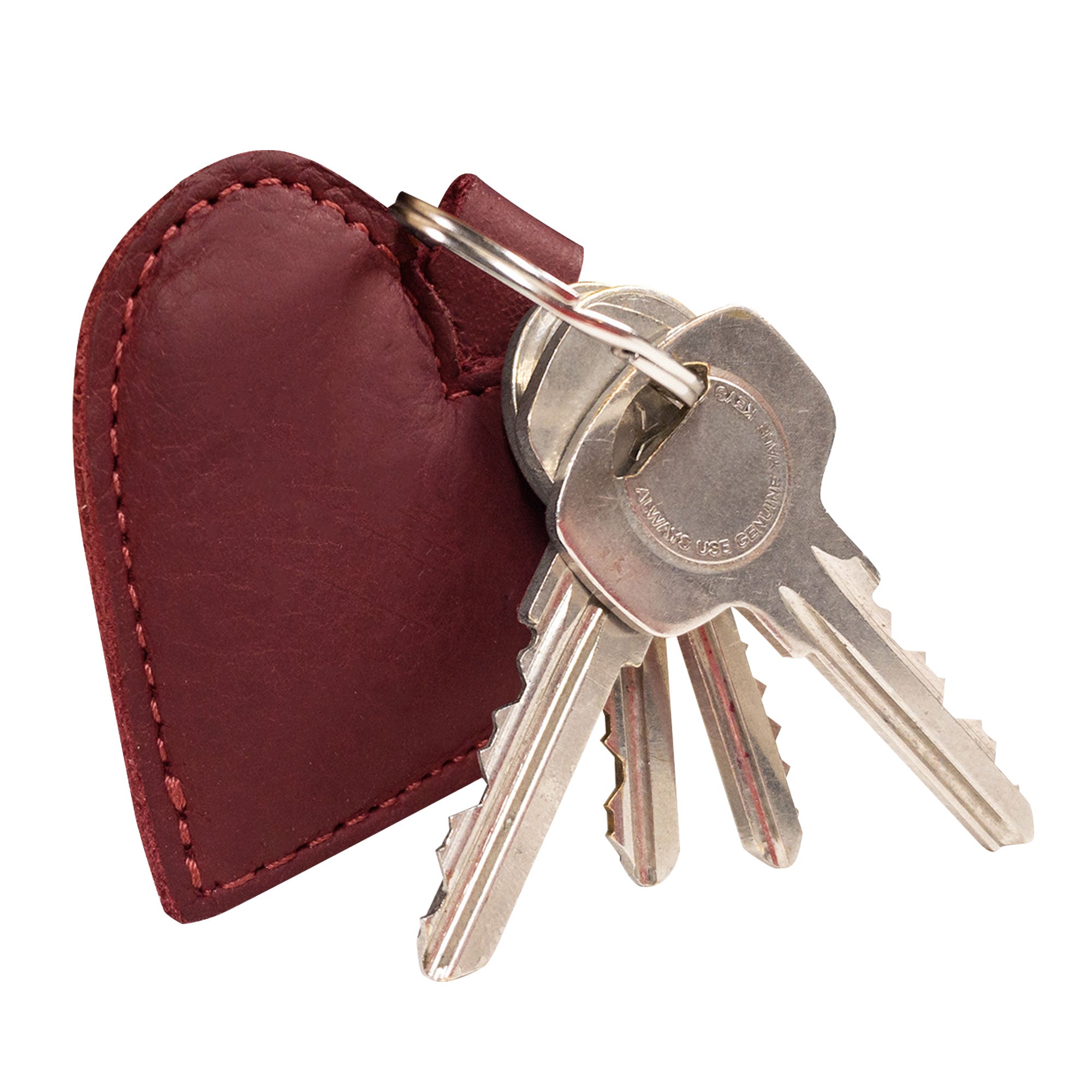 Close-up view of the Heart Keychain by Hide & Drink, showcasing its heart shape and rich leather texture. This heart-shape keychain doubles as a key organizer and is crafted with fire branded detailing. A testament to artisan handmade craftsmanship in La Antigua Guatemala & Oaxaca Mexico, it’s a must-have for anyone seeking cute accessories.