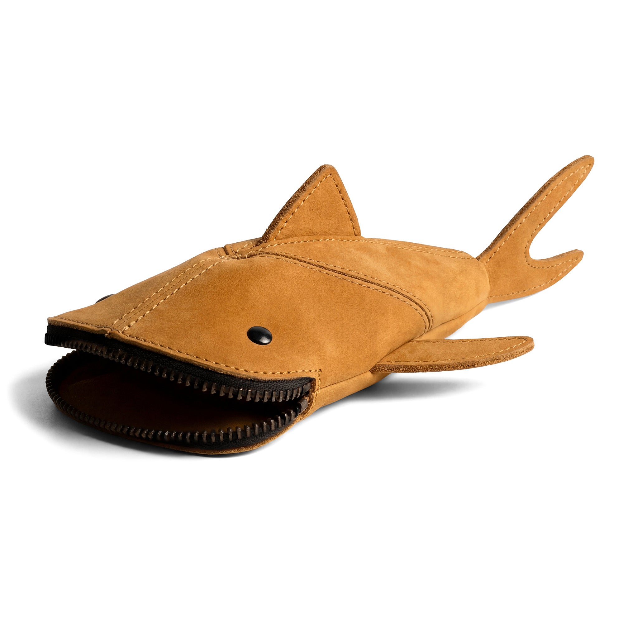 Showing the exterior of the Hide & Drink Leather Shark Pouch, designed in the shape of a shark. This fashionable pouch doubles as a scissors case and a shark shaped cable holder. It's crafted from durable full grain leather, showcasing the unique artistry of small batch production.
