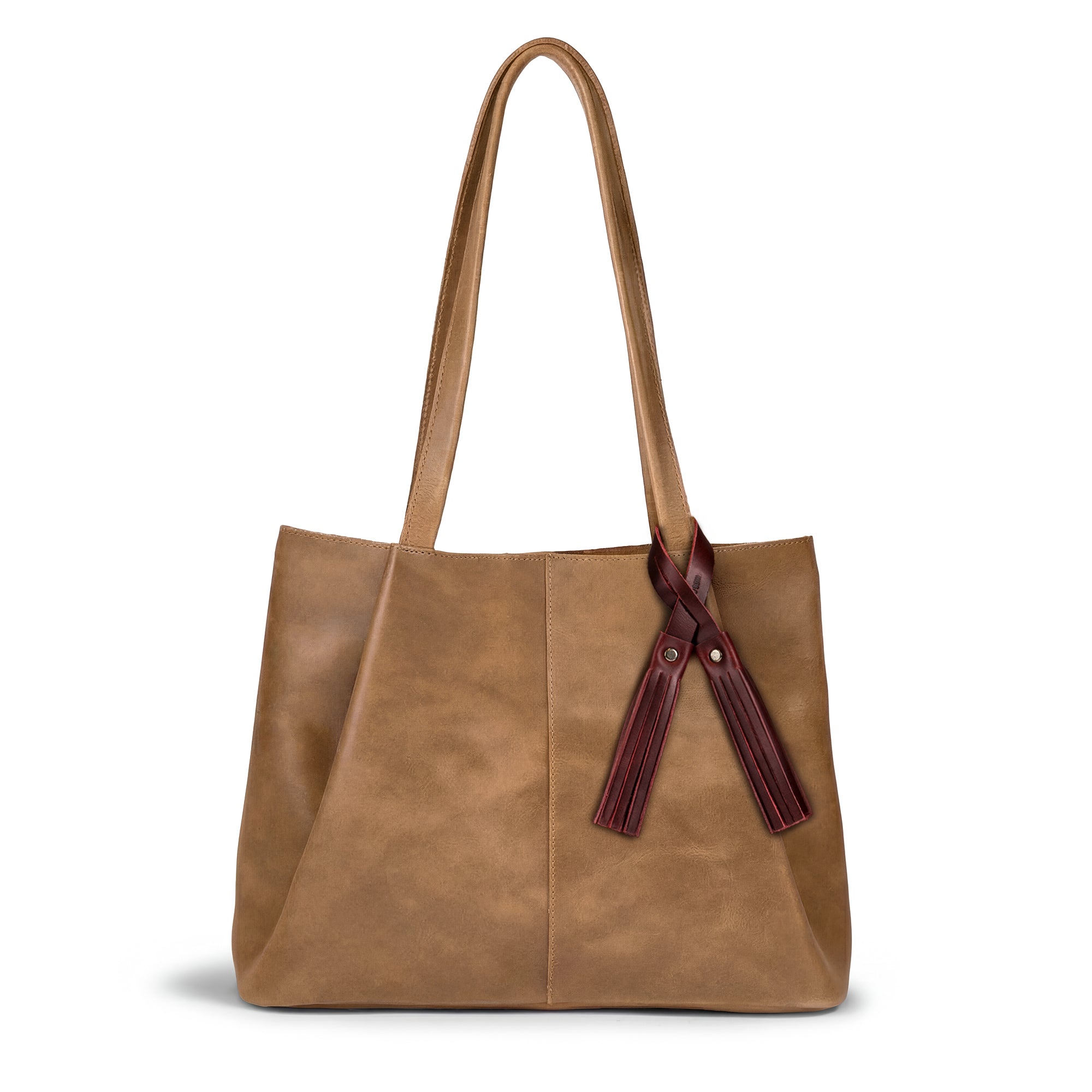 Stylish tote bag adorned with the Tassel Bag Charm Sangria by Hide & Drink. This charm serves as a chic purse charm for tote & backpacks, showcasing unique full grain leather craftsmanship. As part of the Hide & Drink Bag Charms collection, it's an ideal ornament for women, featuring artisan small batch production techniques, hand cut, hand sewn, and fire branded elements, all handmade in La Antigua Guatemala & Oaxaca Mexico.