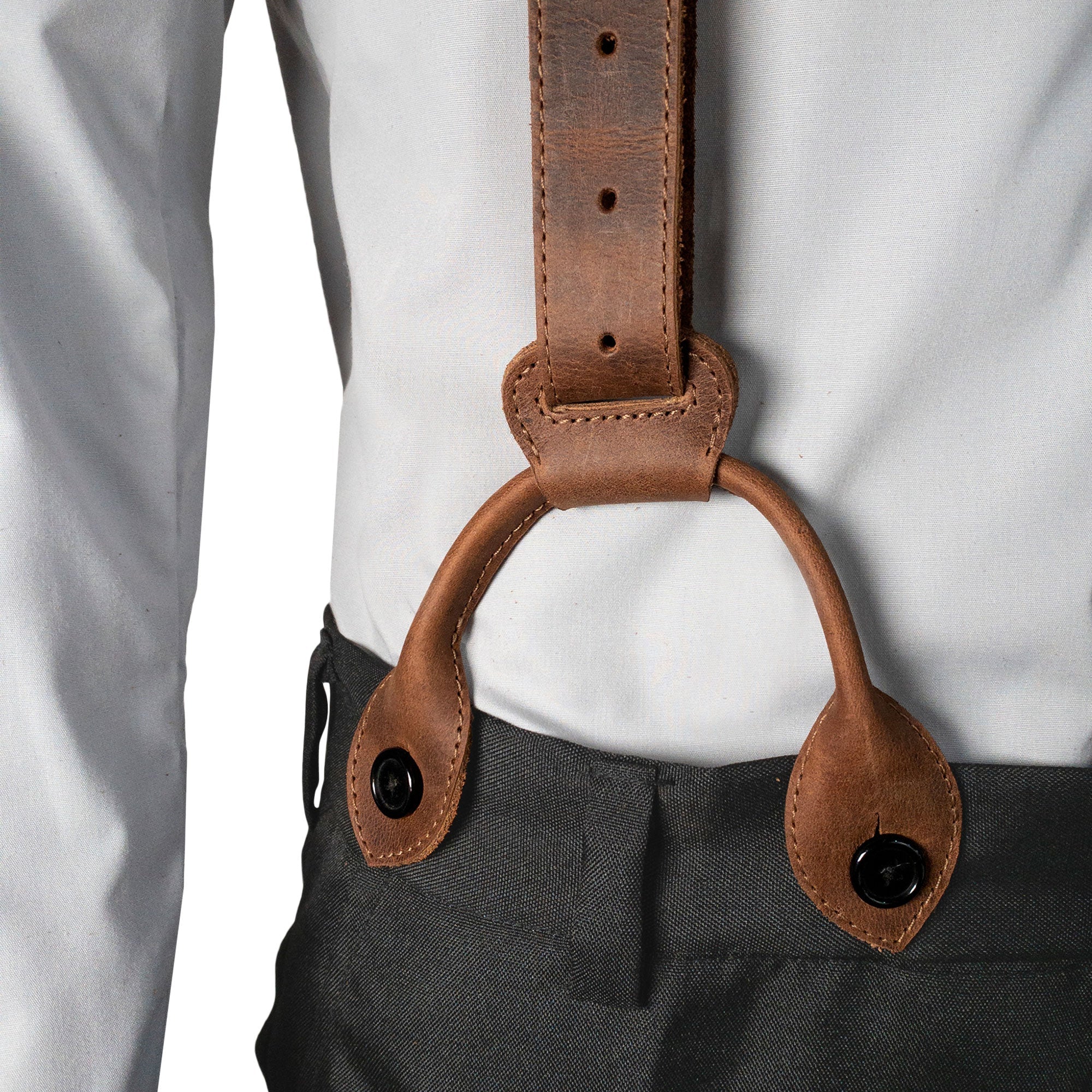 Set of 3 Button End Attachments for Suspenders by Hide & Groom, displayed on a model's outfit. Ideal for formal occasions like dinner parties, these attachments are crafted from full grain leather. Enjoy artisan quality with small batch production and fire branded details, all handmade in La Antigua Guatemala.