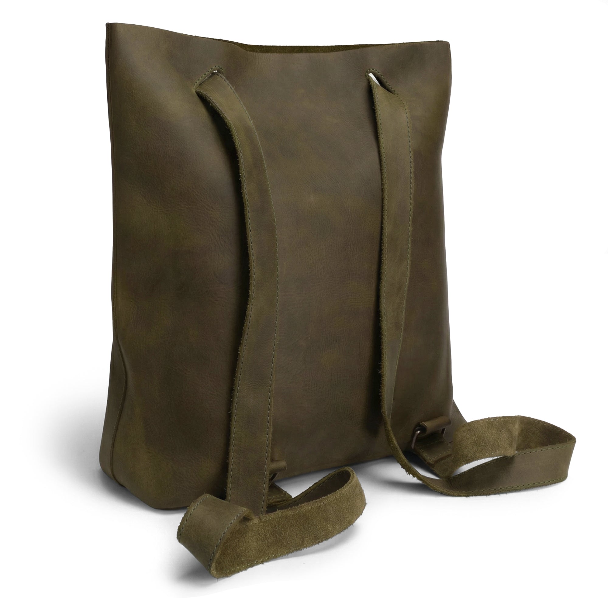 The back view of the Convertible Backpack to Shoulder Bag by Heather's demonstrates its stylish design made from durable full grain leather. This squared purse emphasizes its spaciousness and the small batch production that signifies quality craftsmanship. Artisan-made in La Antigua Guatemala & Oaxaca Mexico, it combines practicality with elegance in every hand cut, hand sewn, and fire branded detail.