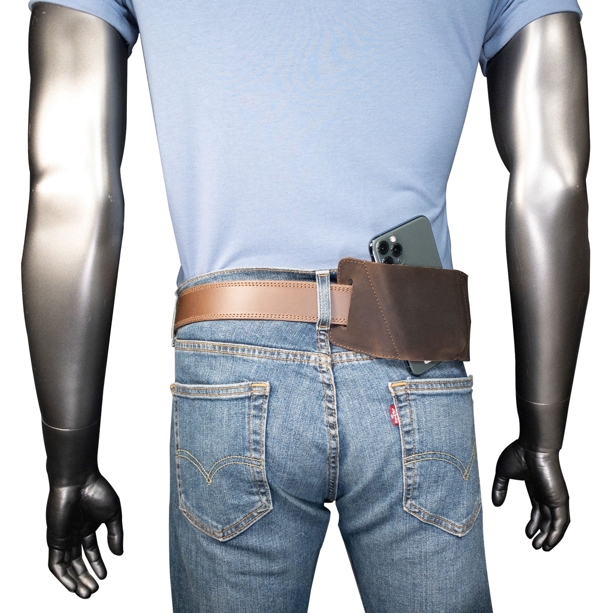 A model wearing the Rustic Waist Holster for Apple iPhone 14 Pro Max by Hide & Drink, demonstrating its practical use. This Full Grain Leather Waist Holster for Apple iPhone 14 Pro Max is handmade, highlighting the craftsmanship in each hand cut and fire branded detail, made in La Antigua Guatemala & Oaxaca Mexico.