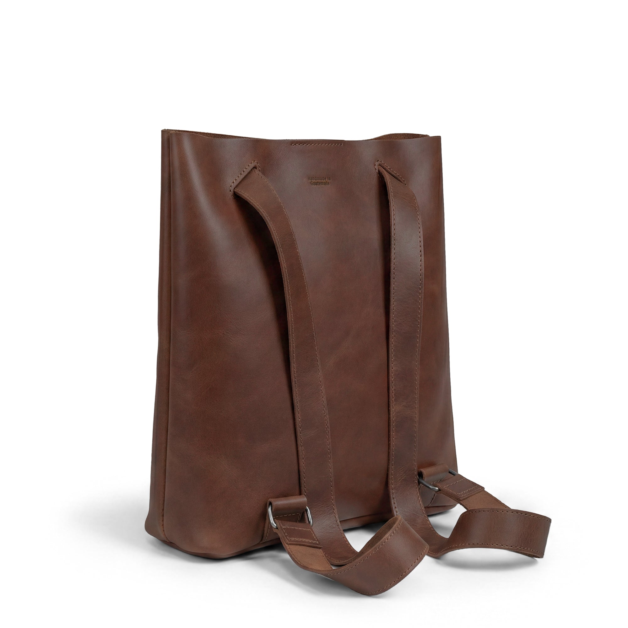 Side view of Heather's Convertible Backpack to Shoulder Bag, highlighting its sturdy straps and elegant Full Grain Leather finish. This Spacious Crossbody for Women accentuates the Squared Purse design, embodying Small Batch Production techniques with hand cut and hand sewn craftsmanship from artisans in La Antigua Guatemala & Oaxaca Mexico.